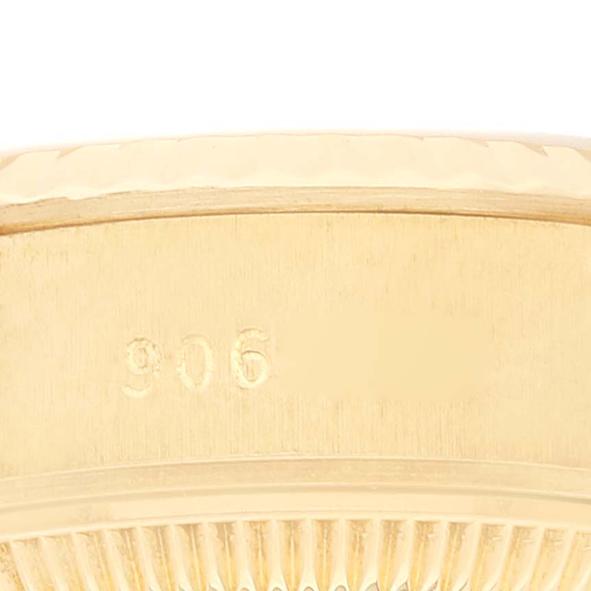 This close-up shows the side of the case of a Rolex President 69178 Women's Yellow Gold Champagne Dial 69178 Women's Yellow Gold Champagne Dial model watch, highlighting the engraved serial number and fluted bezel.