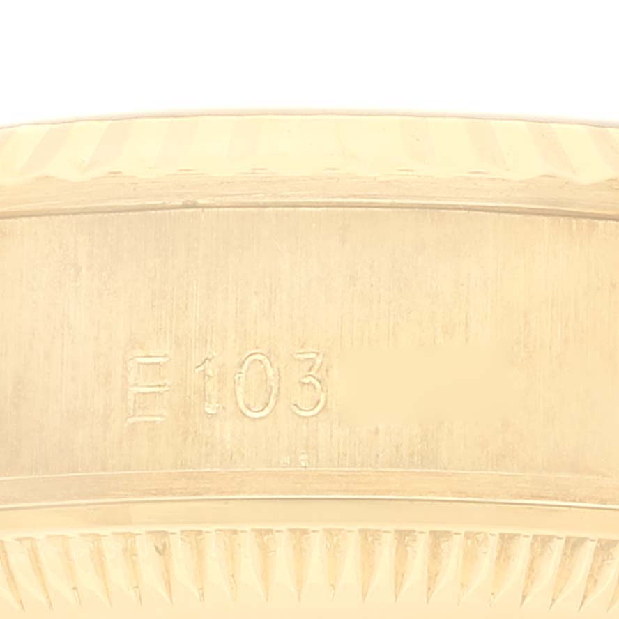 This image shows a close-up of the side of a Rolex President 69178 Women's Yellow Gold Champagne Dial 69178 Women's Yellow Gold Champagne Dial model watch case with the engraving "F 103" visible.