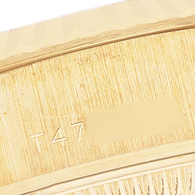 This image shows a close-up of the engraved serial number on the side of a Rolex President 69178 Women's Yellow Gold Champagne Dial 69178 Women's Yellow Gold Champagne Dial model watch.
