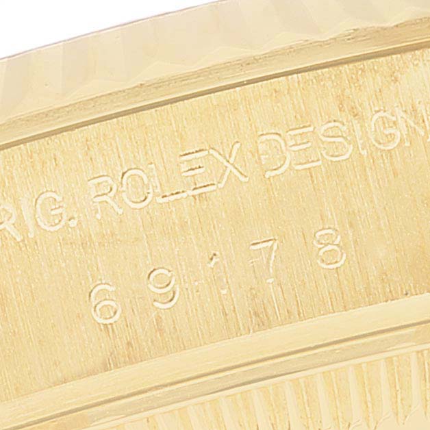 This image shows a close-up of the side of a Rolex President 69178 Women's Yellow Gold Champagne Dial 69178 Women's Yellow Gold Champagne Dial model, highlighting the engraved model number and design detail.