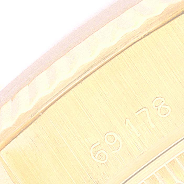 This image shows a close-up of the engraved serial number area on a Rolex President 69178 Women
s Yellow Gold Champagne Dial 69178 Women
s Yellow Gold Champagne Dial model watch.