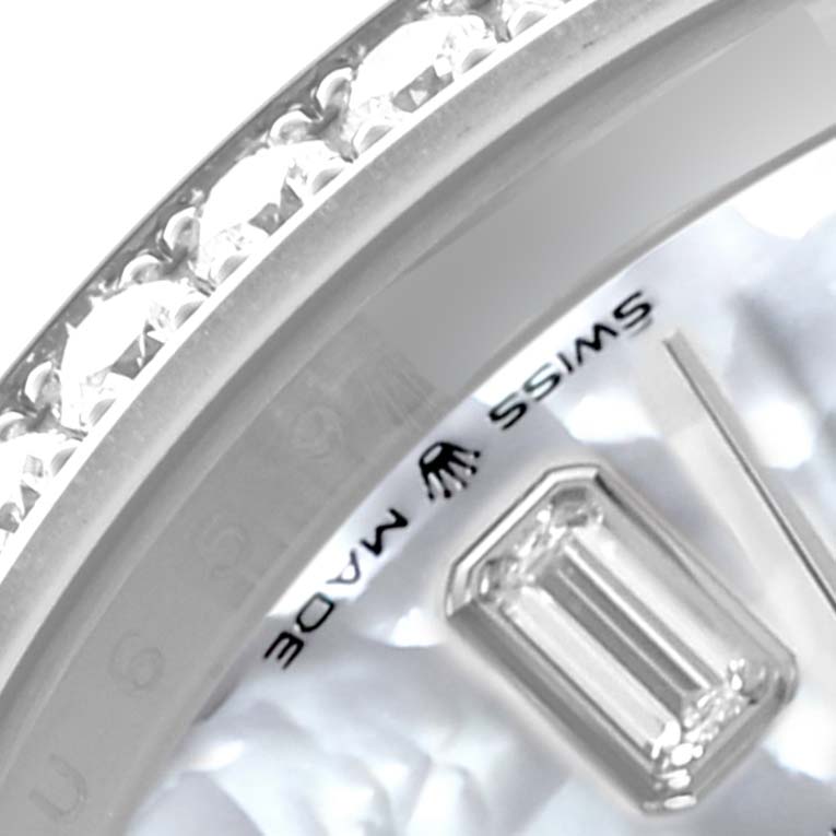 The image shows a close-up of the bezel and part of the dial of a Rolex President 128349 Men's White Gold Mother of Pearl Dial 128349 Men's White Gold Mother of Pearl Dial model watch with visible diamonds and a "Swiss Made" label.