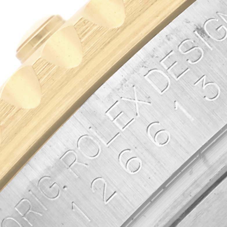 The image shows a close-up of the engraved edge and bezel of a Rolex Submariner 126613 Men's Steel and Gold (two tone) Blue Dial 126613 Men's Steel and Gold (two tone) Blue Dial watch.