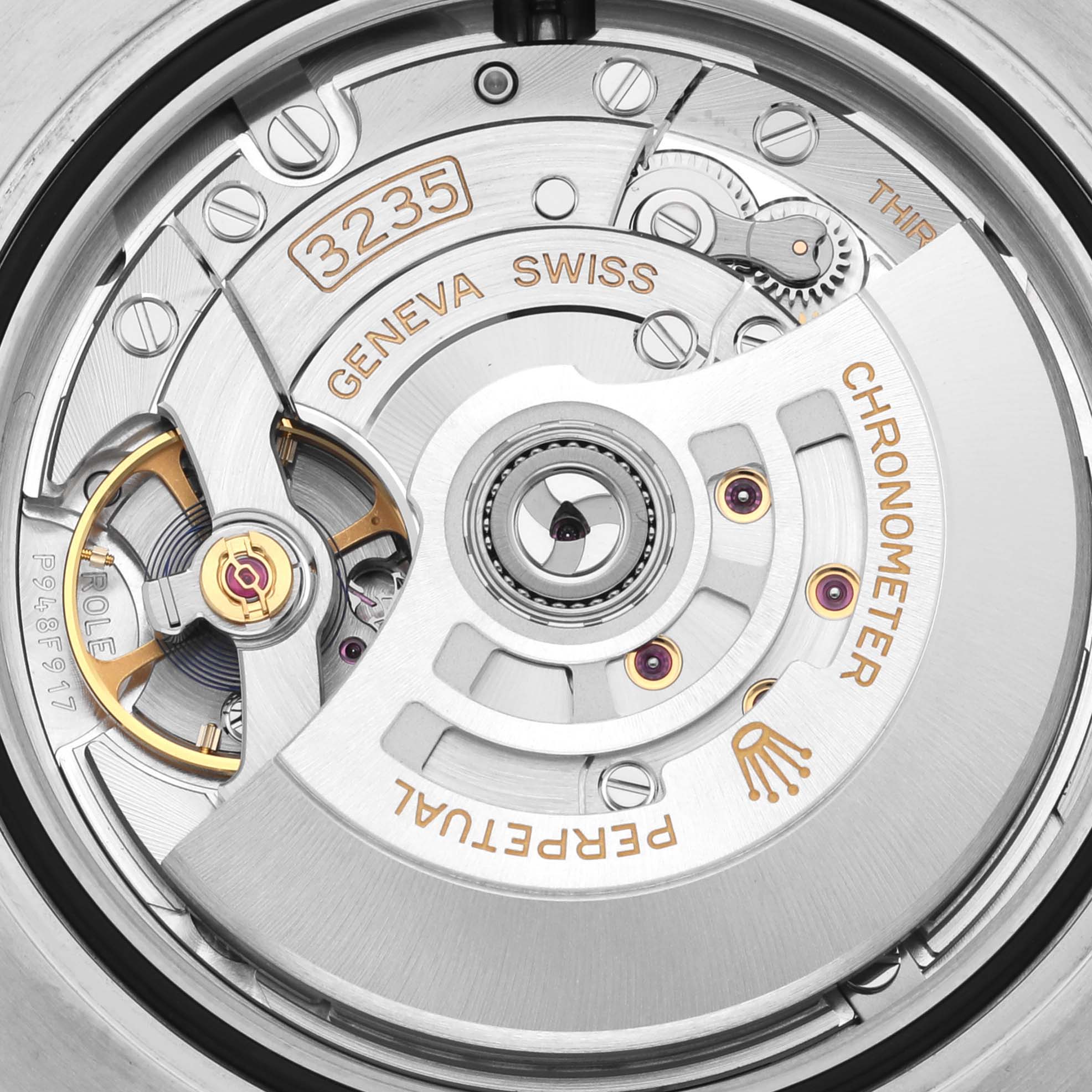 The image shows the movement and intricate mechanics of a Rolex Submariner 126613 Men's Steel and Gold (two tone) Blue Dial 126613 Men's Steel and Gold (two tone) Blue Dial watch, focusing on the rotor and other internal components.