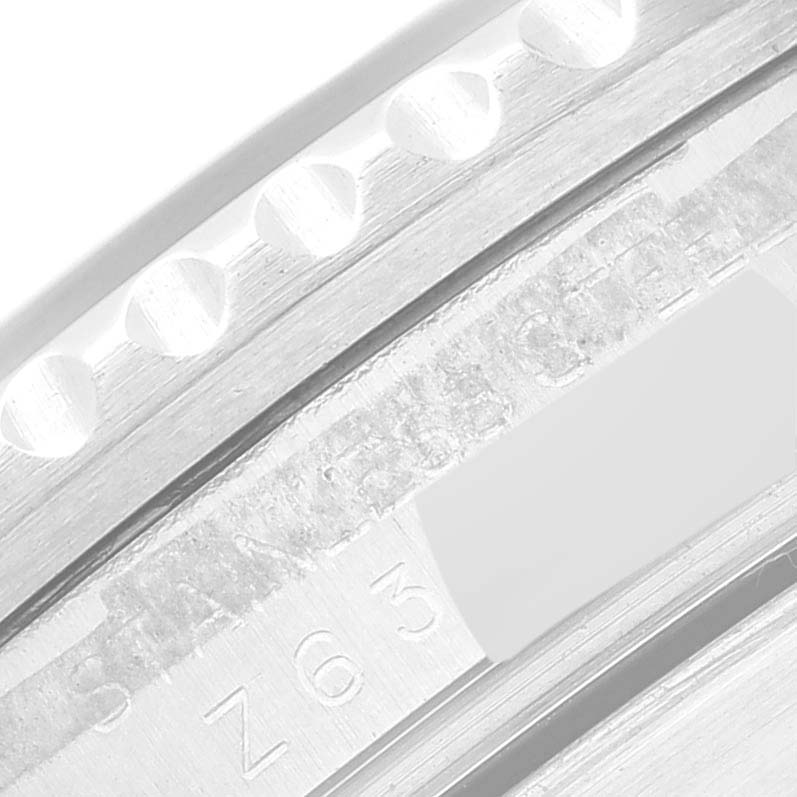 Close-up angle of the stainless steel bezel and serial number engraving on a Rolex Submariner 16610 Men's Stainless Steel Black Dial 16610 Men's Stainless Steel Black Dial watch.