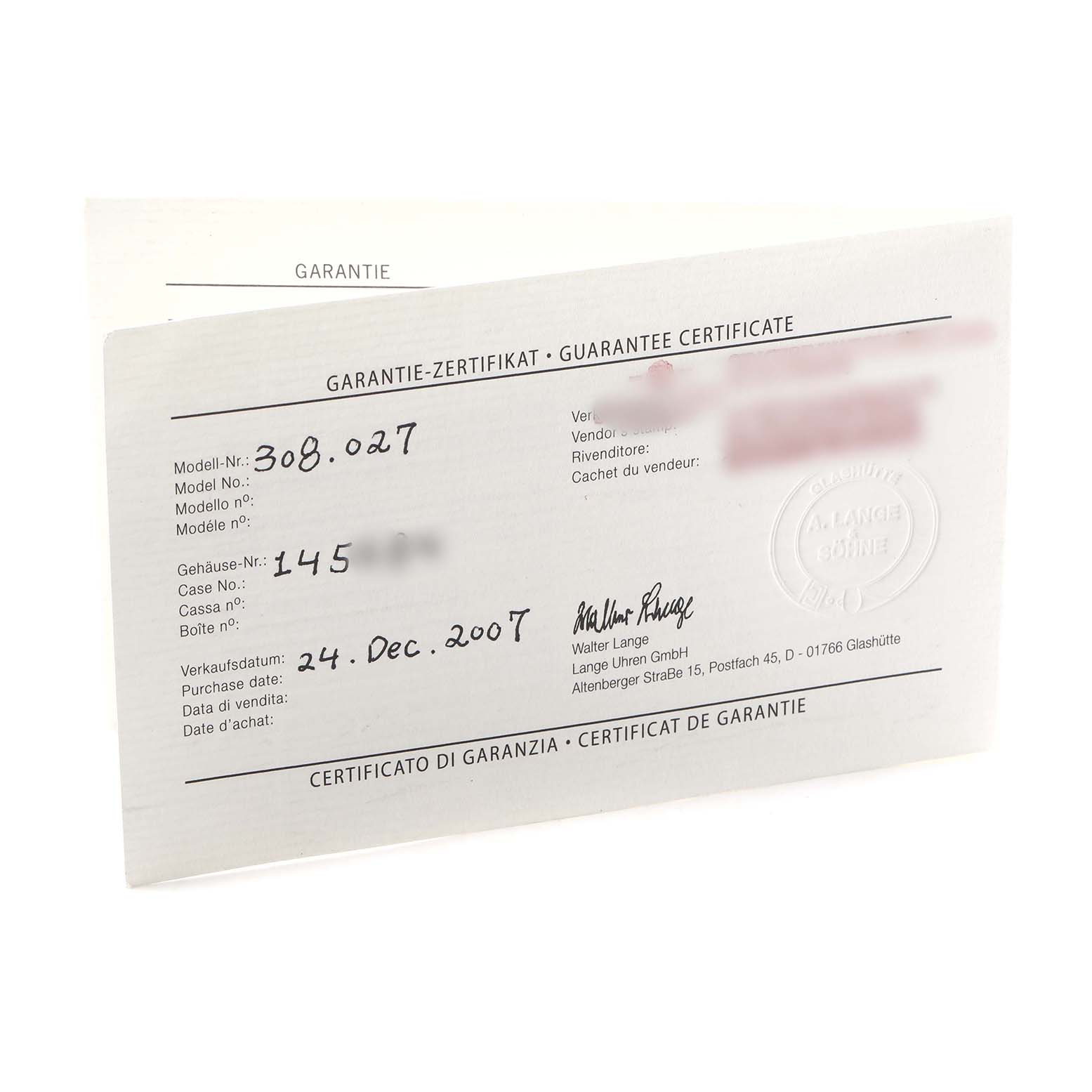 The image shows a Glashütte Original guarantee certificate angled to the left, detailing model and case numbers.