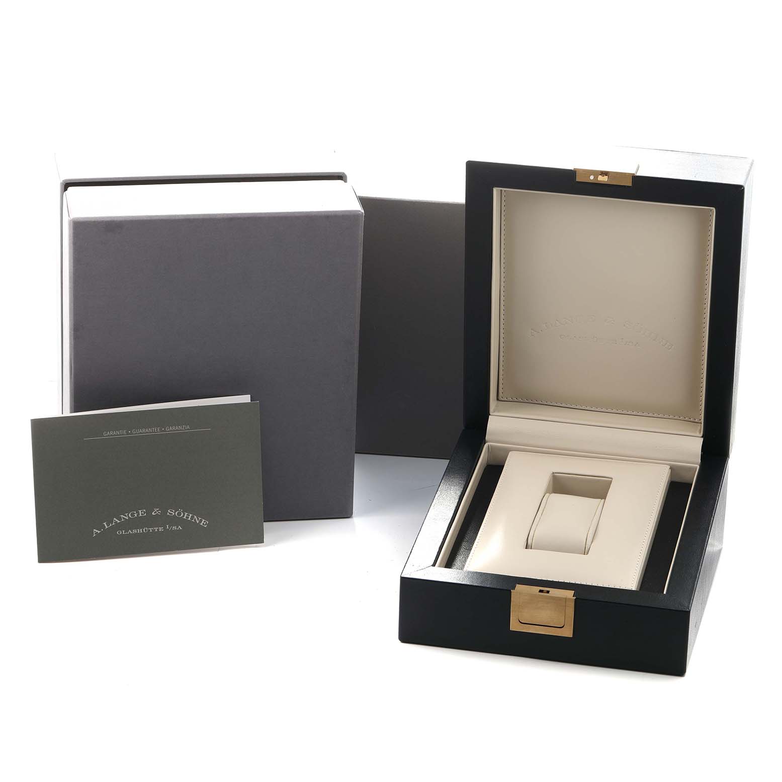 The image shows the open packaging of the 1815 model by A. Lange & Söhne, including a presentation box and a booklet.