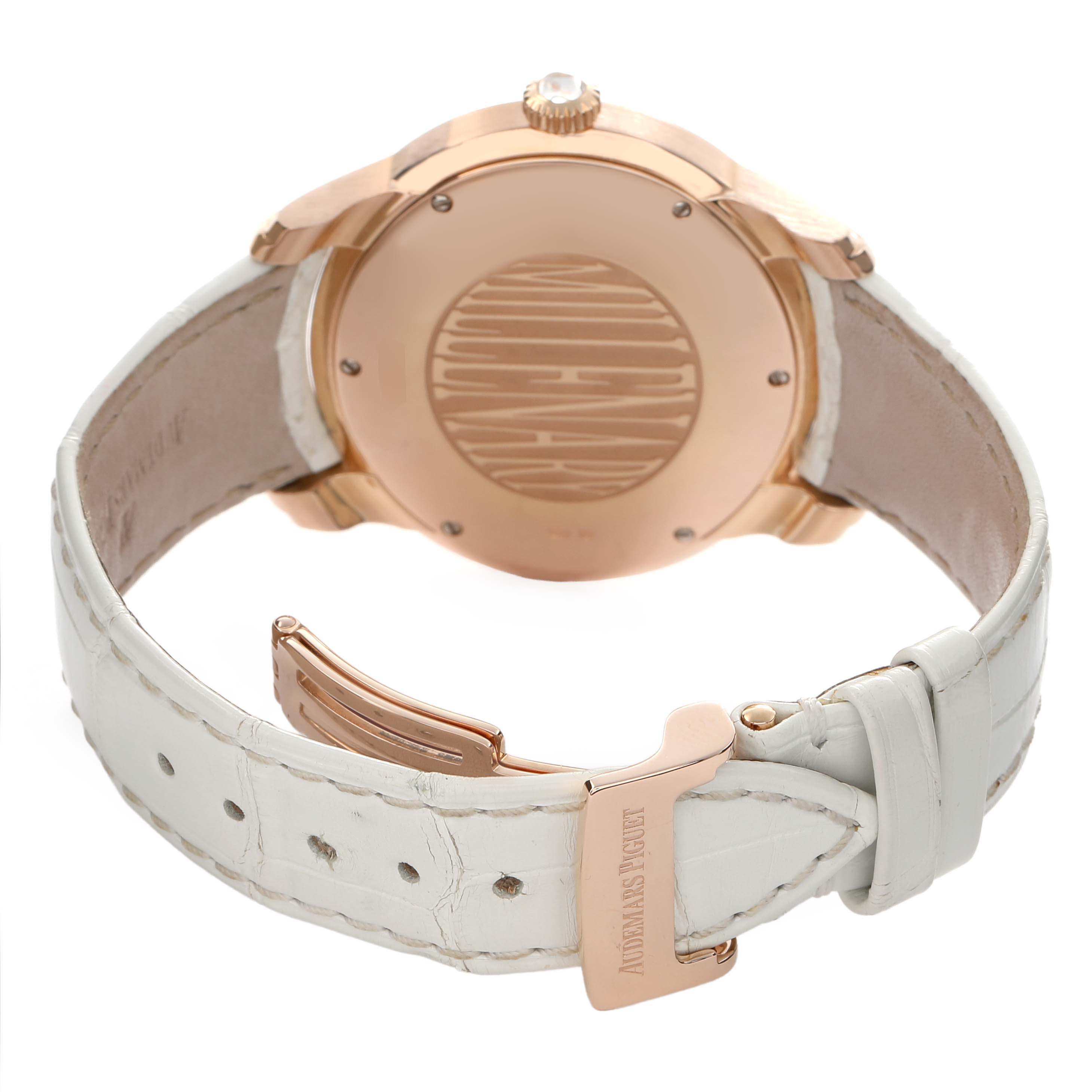 The image shows the back of the Audemars Piguet Millenary 77301OR Women's Rose Gold Silver Dial watch, featuring the case back, crown, and white leather strap with a clasp.