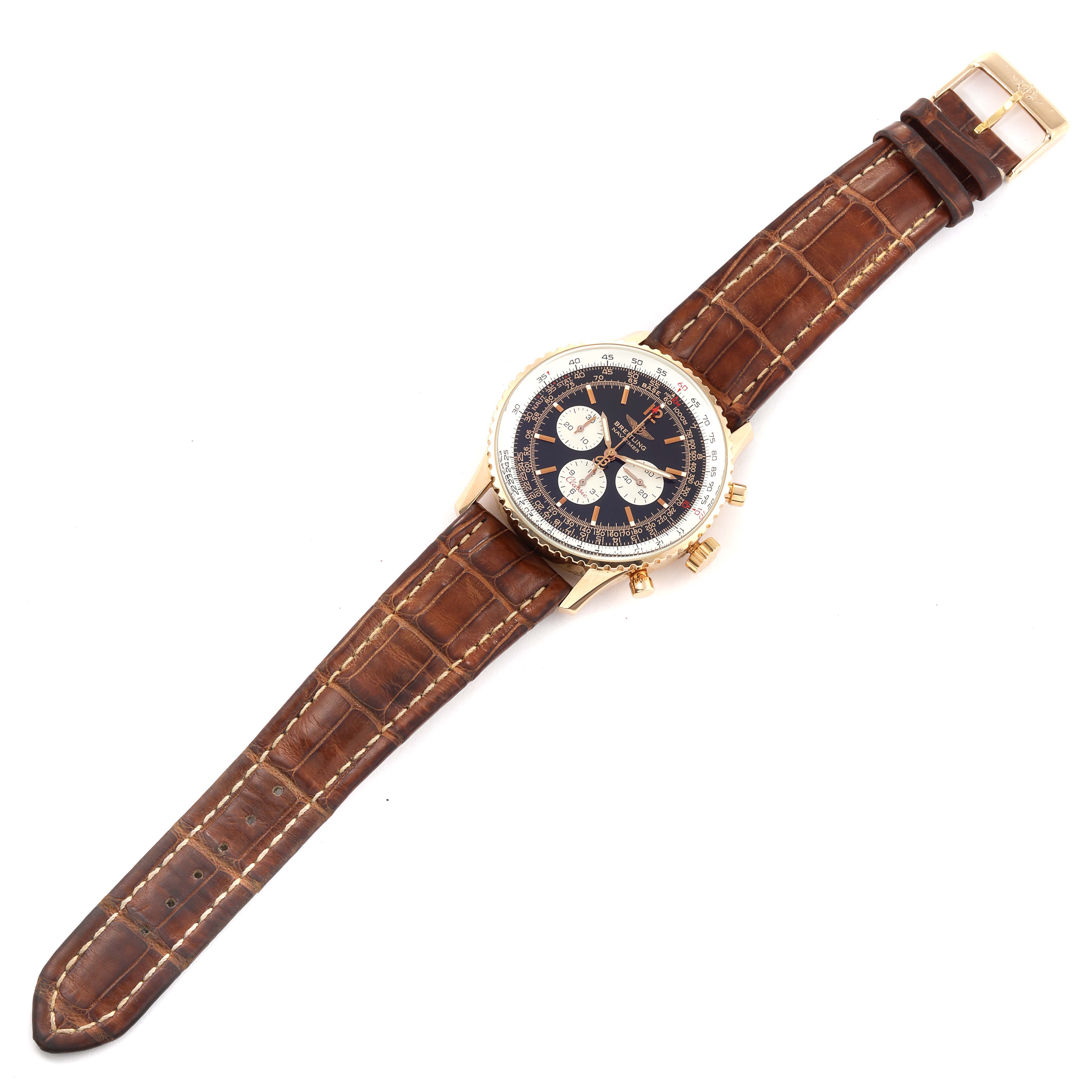The image shows an overhead view of a Breitling Limited Series watch with a brown leather strap and gold case.