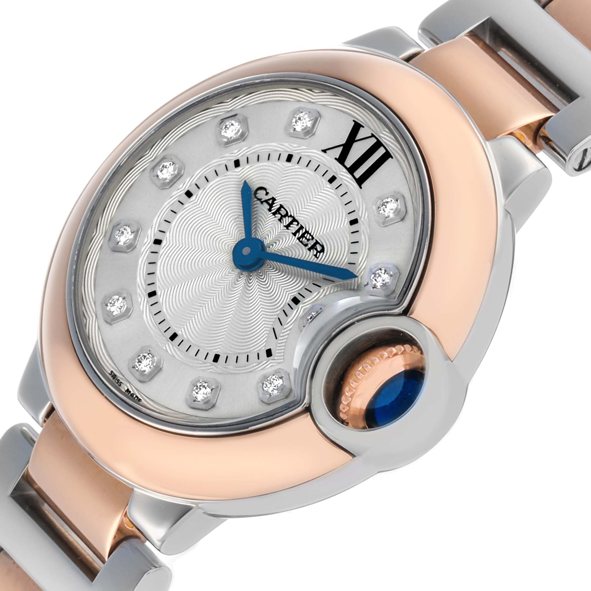 The Cartier Ballon Bleu W3BB0005 Women's Steel and Gold (two tone) Silver Dial watch is shown from an angled close-up, highlighting its dial, Roman numeral, and blue cabochon crown.