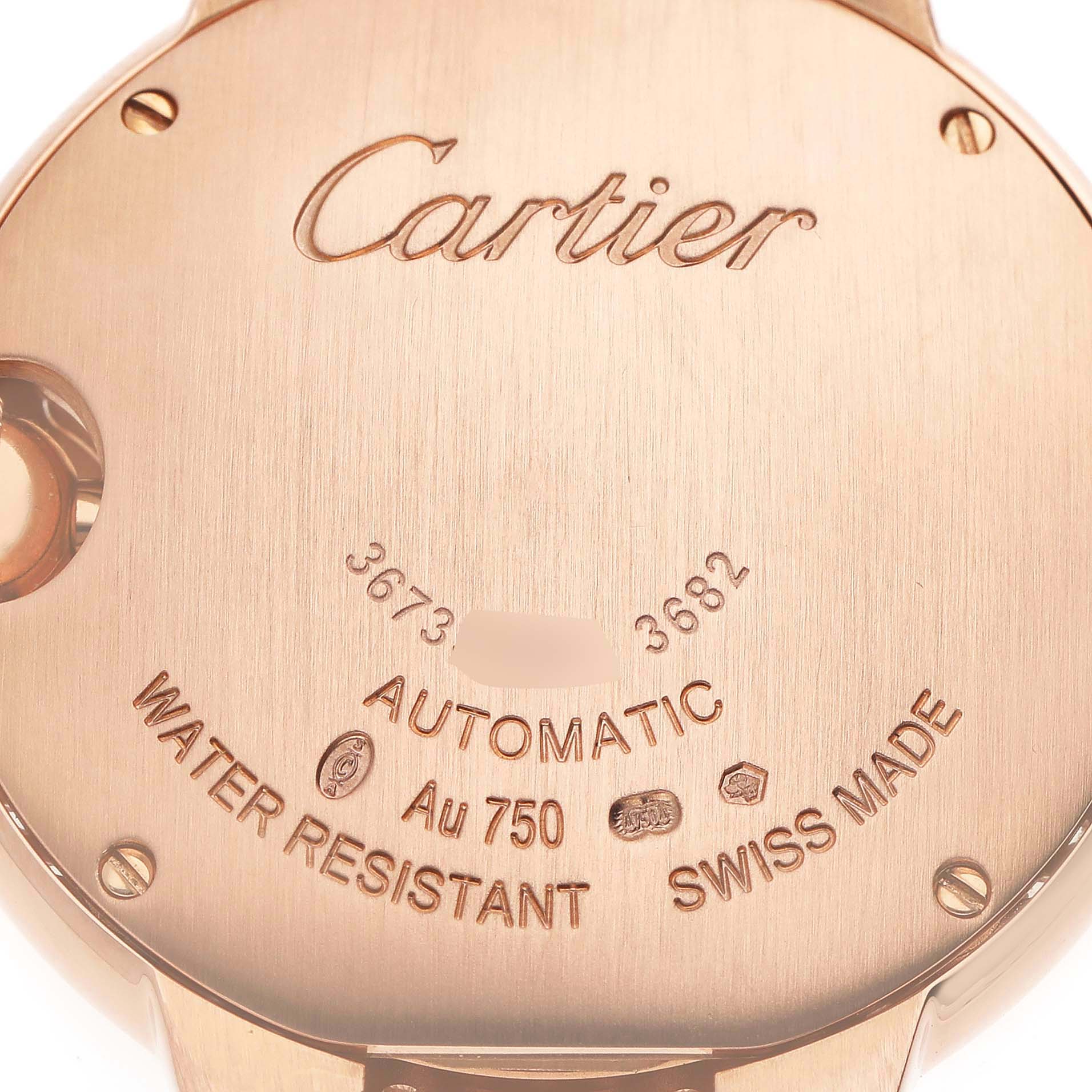 The image shows the back of a Ballon Bleu de Cartier watch, highlighting engravings like "Cartier," "Automatic," and "Swiss Made."