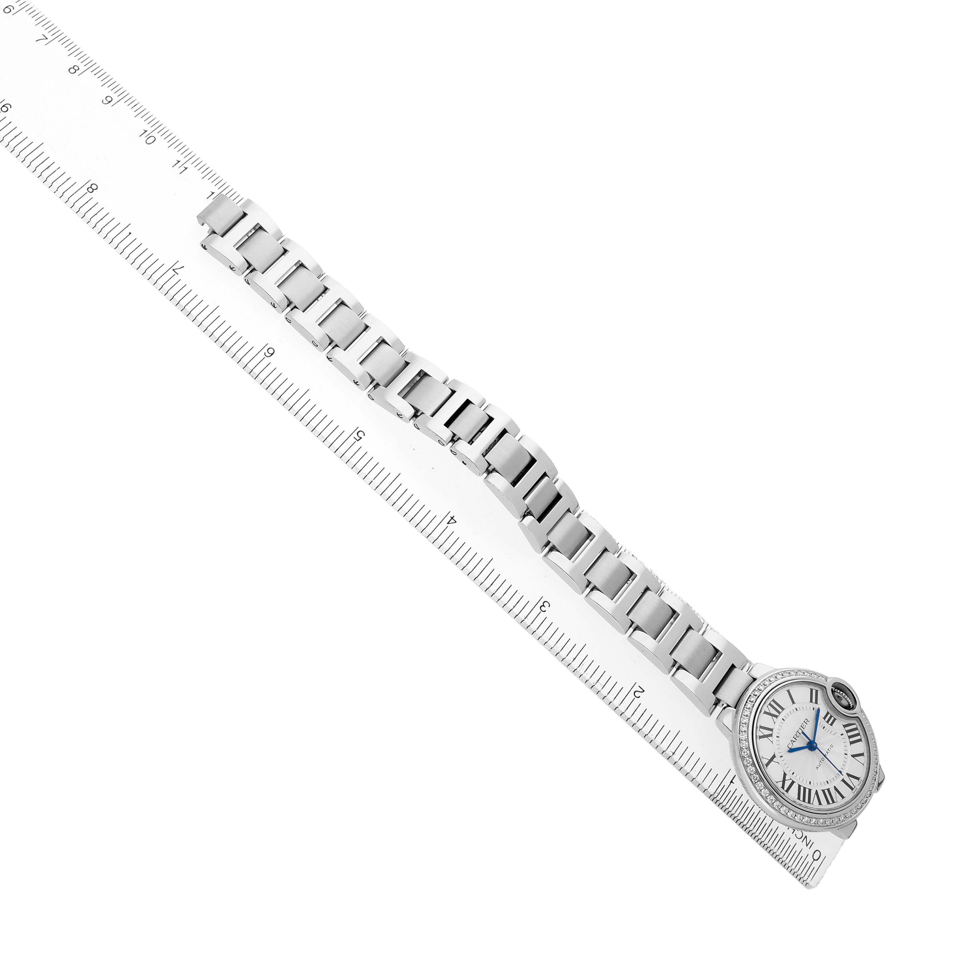 The Cartier Ballon Bleu W4BB0016 Women's Stainless Steel Silver Dial watch is shown from a top view with its full bracelet and round face visible, alongside a ruler.
