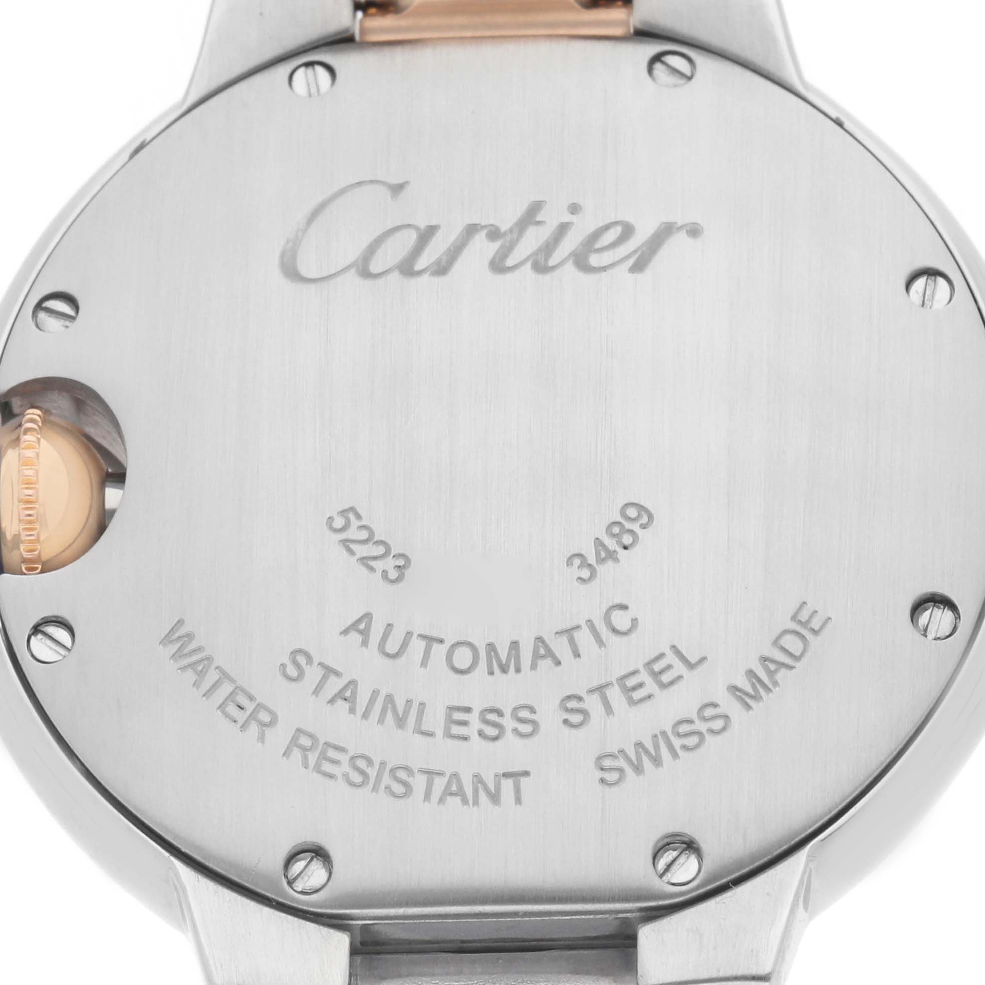 The image shows the back of a Cartier Ballon Bleu W6920070 Women's Steel and Gold (two tone) Mother of Pearl Dial watch, highlighting its stainless steel case and engraved details.