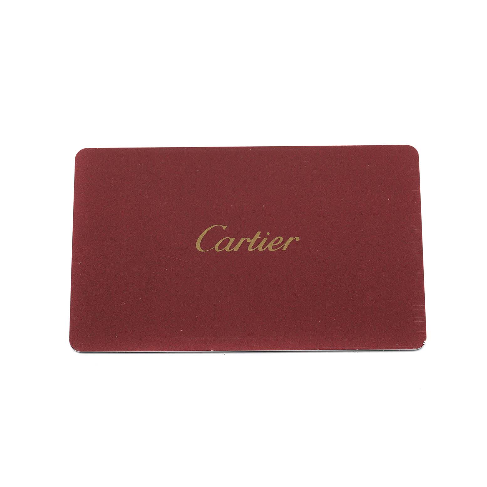 The image shows a Cartier card, likely an accessory for the Ballon Bleu watch, featuring the brand name in gold on a red background.