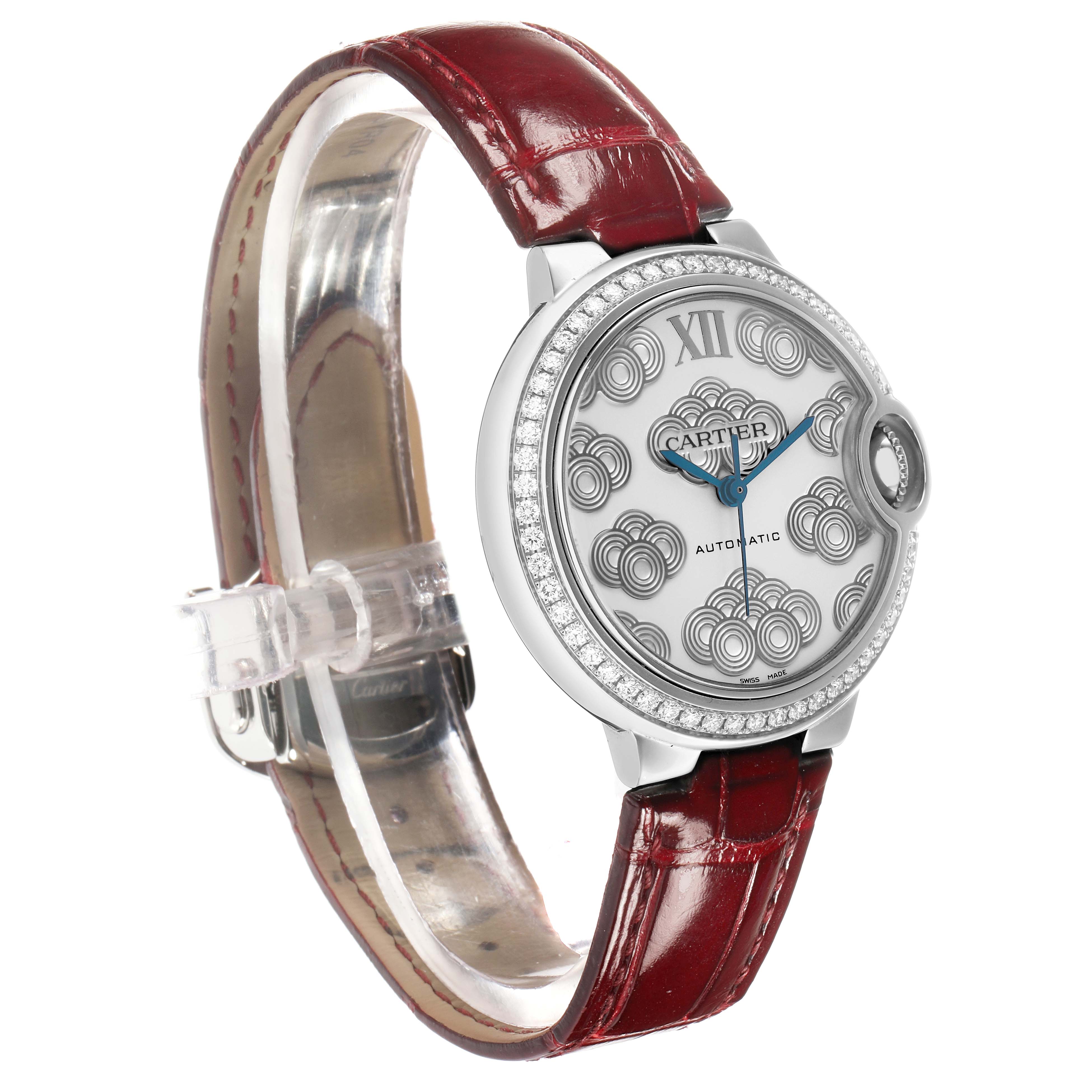The Cartier Ballon Bleu W4BB0027 Women's Stainless Steel Silver Dial watch is shown at a three-quarter angle, highlighting the face, diamond bezel, and red leather strap.