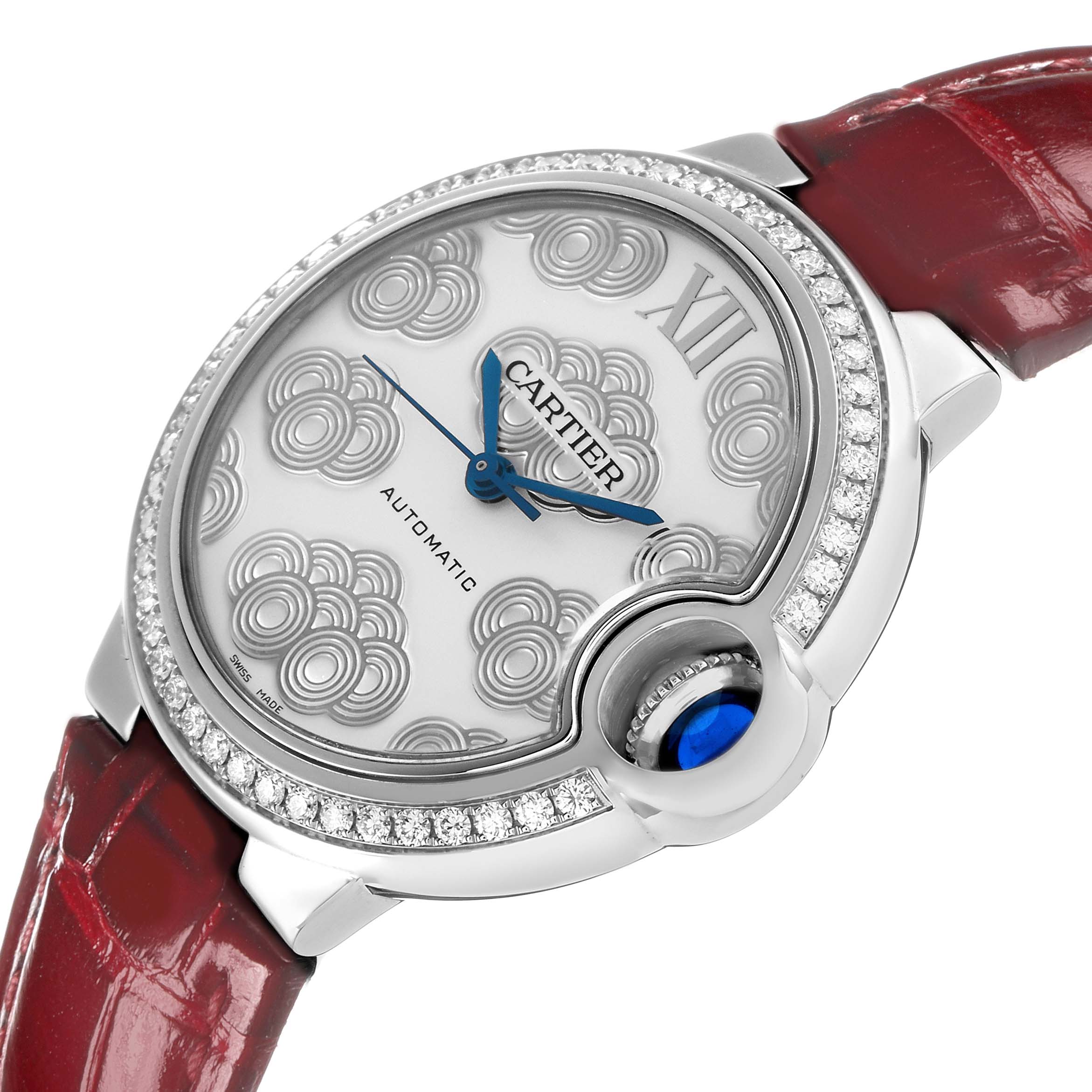 The Cartier Ballon Bleu W4BB0027 Women's Stainless Steel Silver Dial watch is shown at an angled side view, highlighting the dial, crown, and red leather strap.