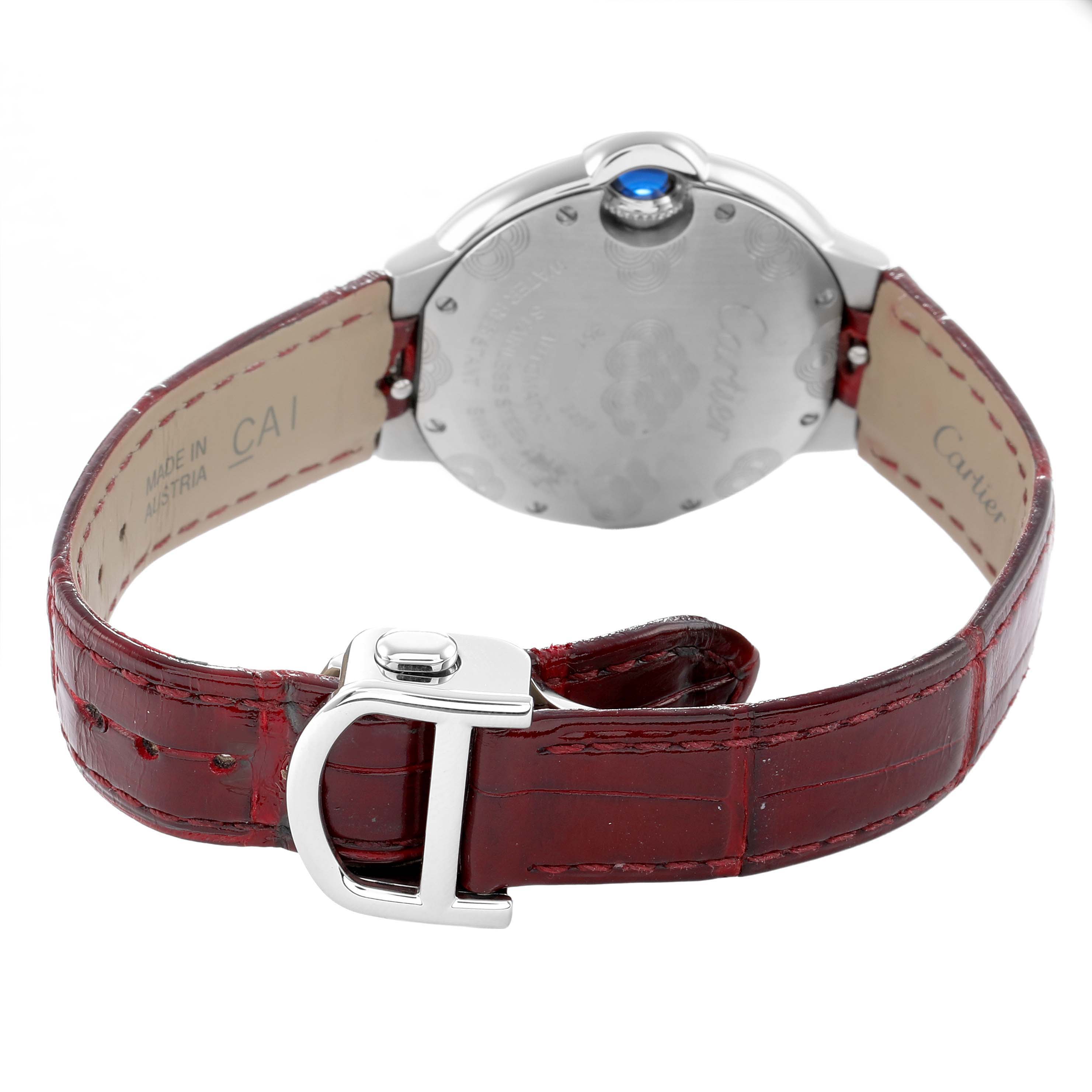 The image shows the back of a Cartier Ballon Bleu W4BB0027 Women's Stainless Steel Silver Dial watch, highlighting its red leather strap and metal clasp.