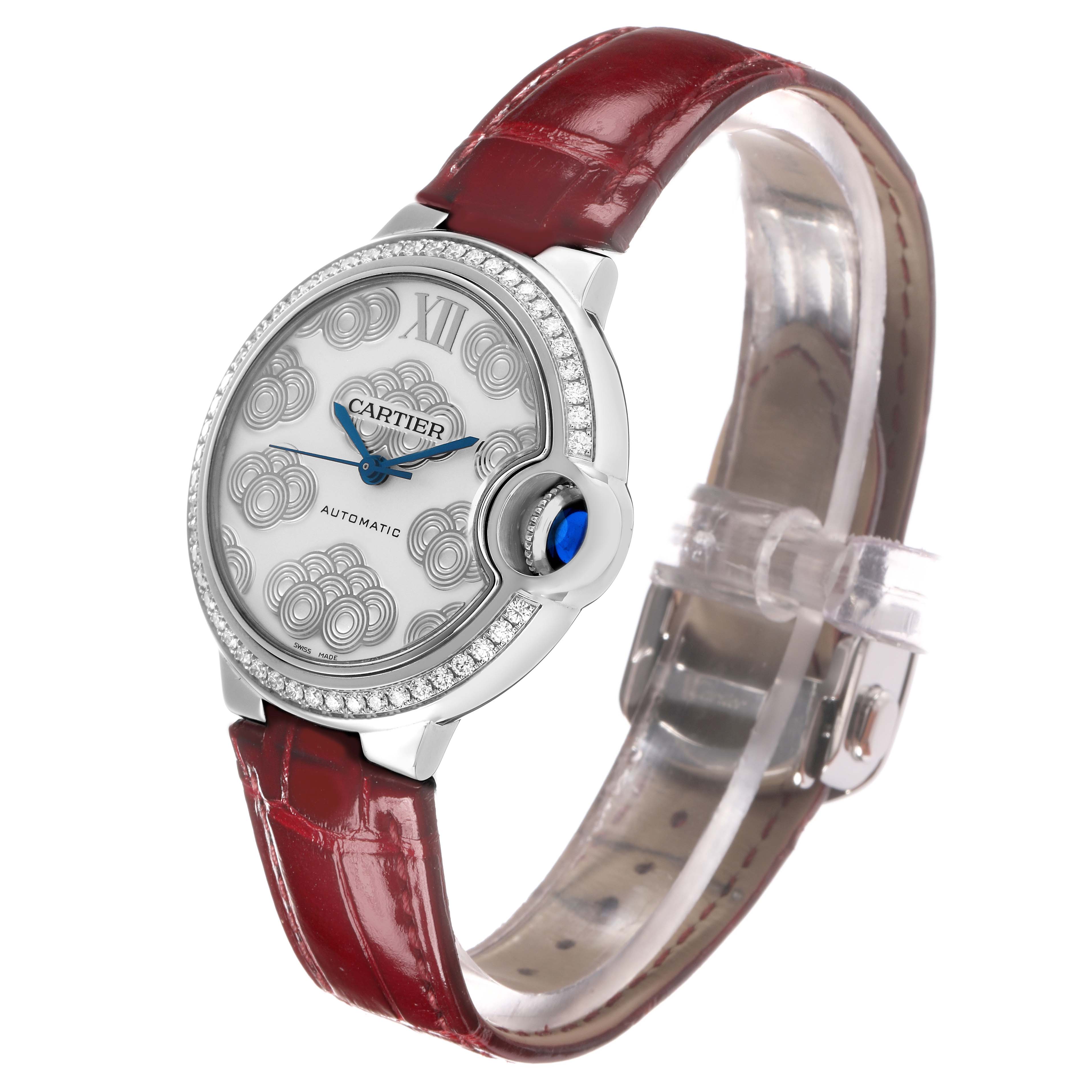 The Cartier Ballon Bleu W4BB0027 Women's Stainless Steel Silver Dial watch is shown at a slight angle, highlighting the face, crown, and burgundy strap.