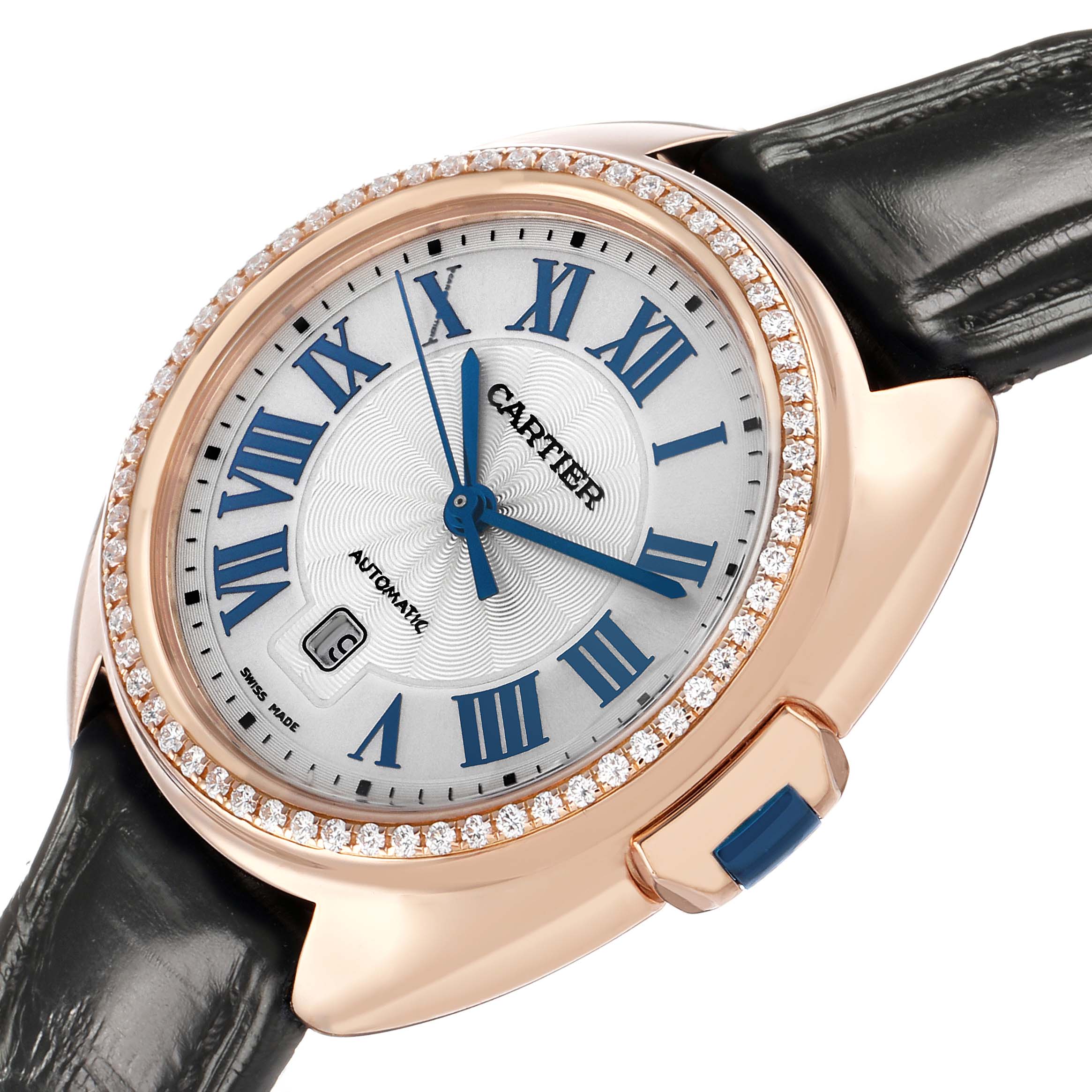 The Cartier Clé watch is shown at an angled view, featuring the face, diamond bezel, and leather strap.