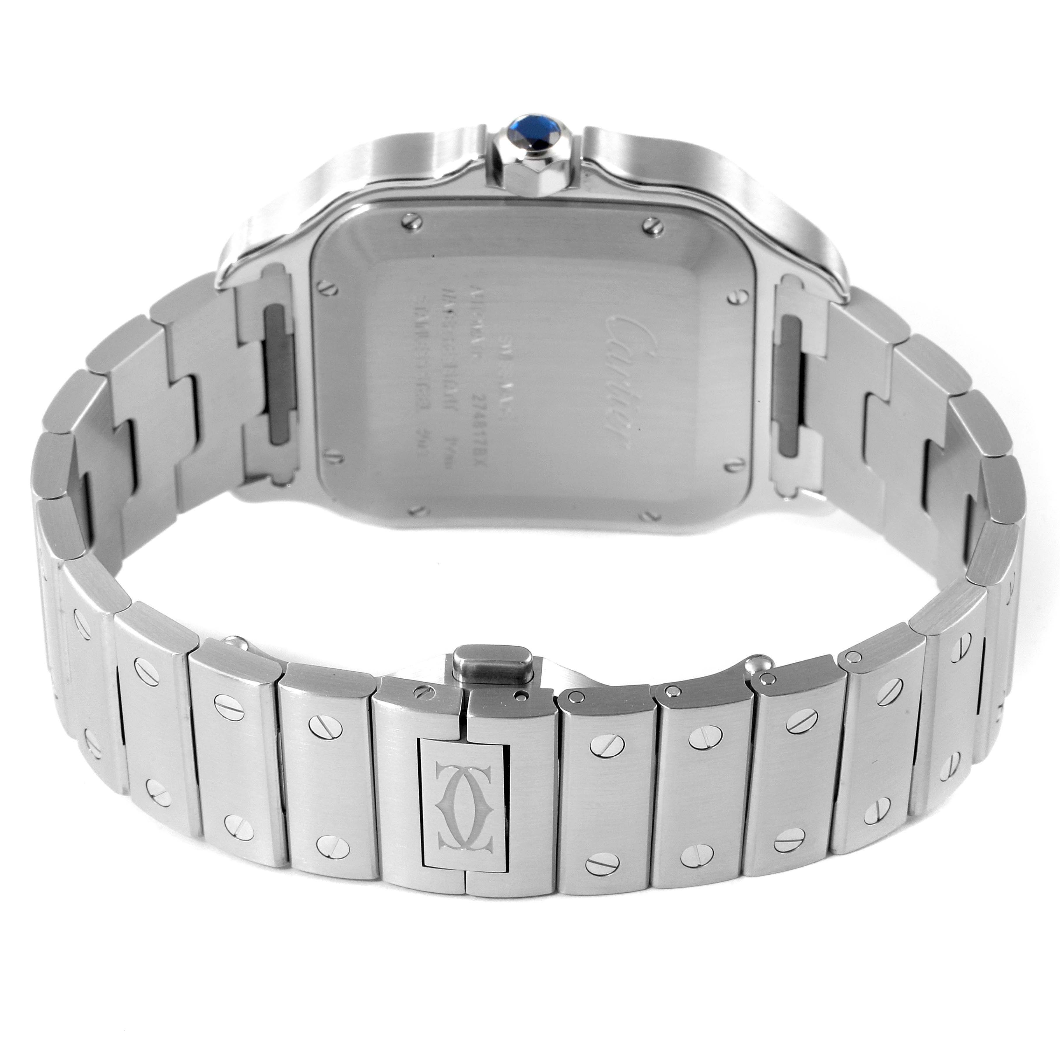 The image shows the back of a Santos model watch by Cartier, highlighting the case back, crown, and bracelet.