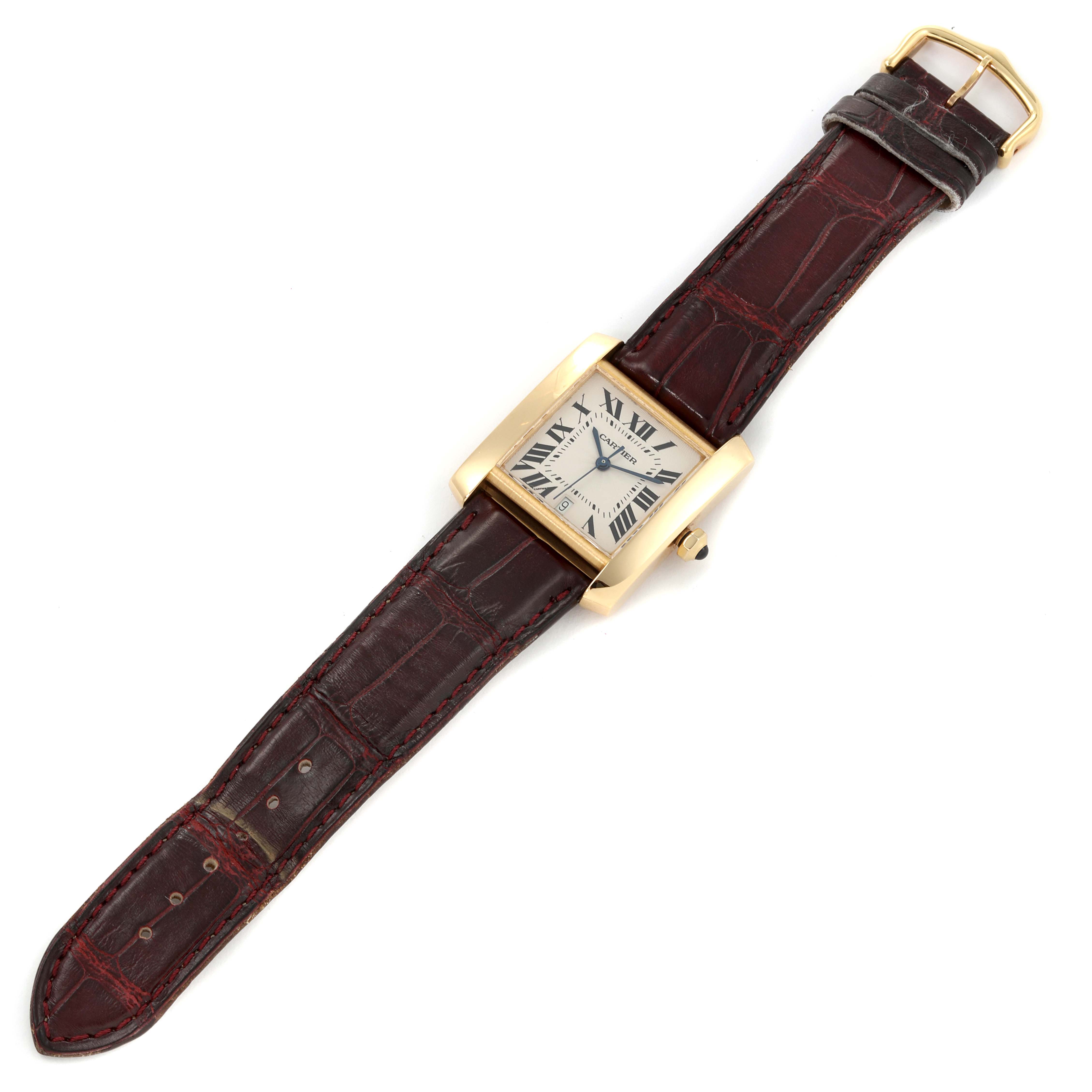 The image shows a Cartier Tank Francaise W5000156 Men's Yellow Gold Silver Dial W5000156 Men's Yellow Gold Silver Dial watch laid flat, featuring its rectangular dial, leather strap, and gold buckle.