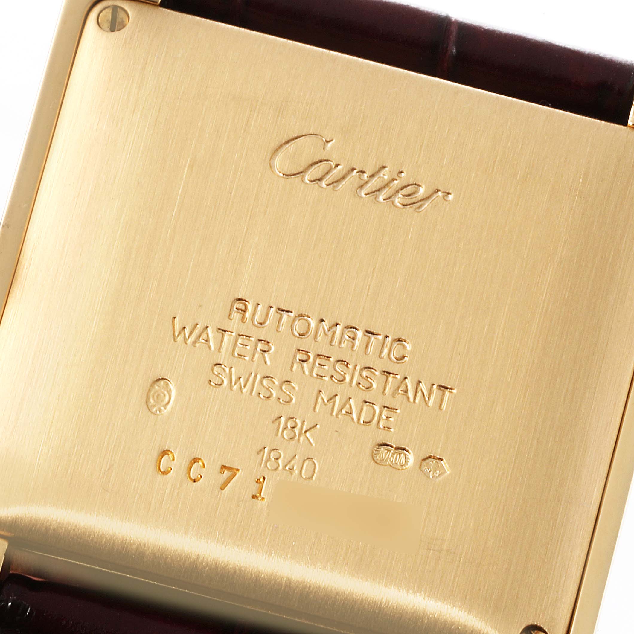 This image shows the back casing of the Cartier Tank Francaise W5000156 Men's Yellow Gold Silver Dial W5000156 Men's Yellow Gold Silver Dial watch, detailing the engravings and metal composition.