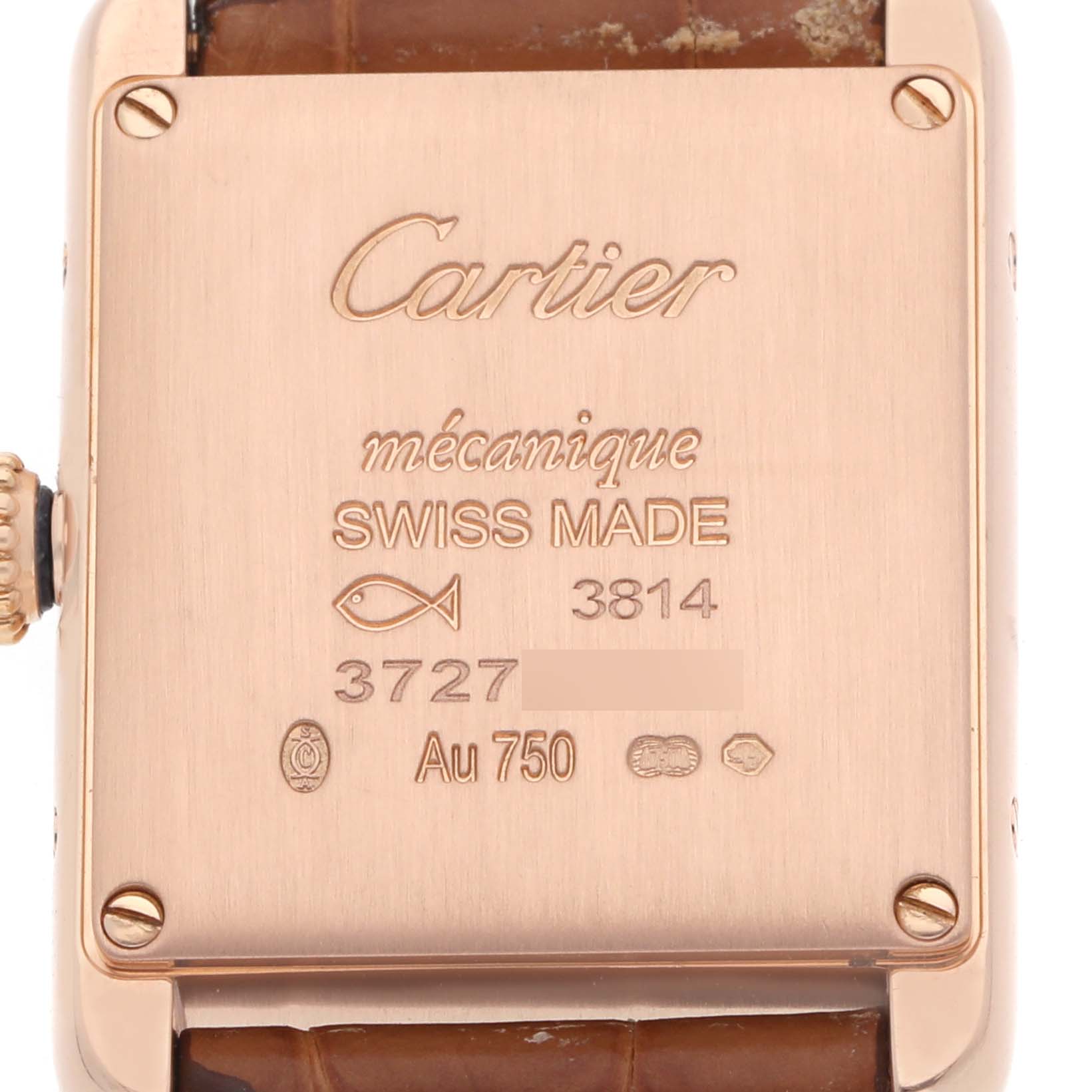 The image shows the back of a Cartier Tank Louis WGTA0010 Women's Rose Gold Silver Dial watch, highlighting engravings and a leather strap edge.
