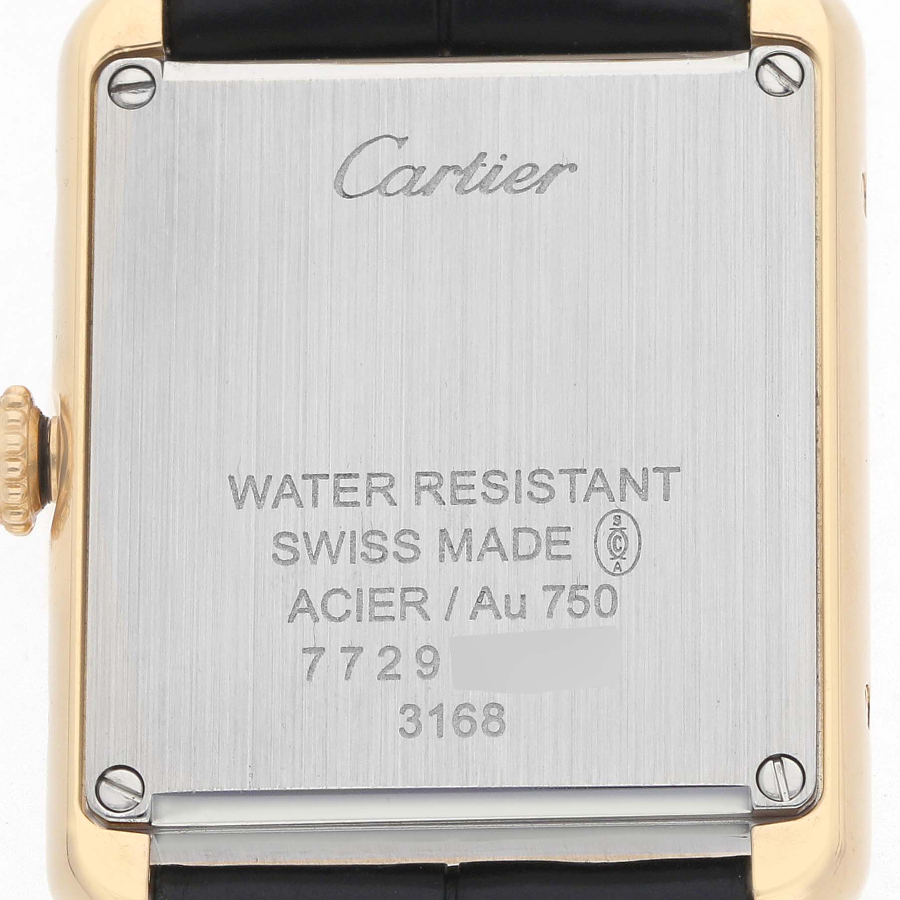 The image shows the back case of a Cartier Tank Solo W5200002 Women's Yellow Gold Silver Dial watch, highlighting the brand and model details.