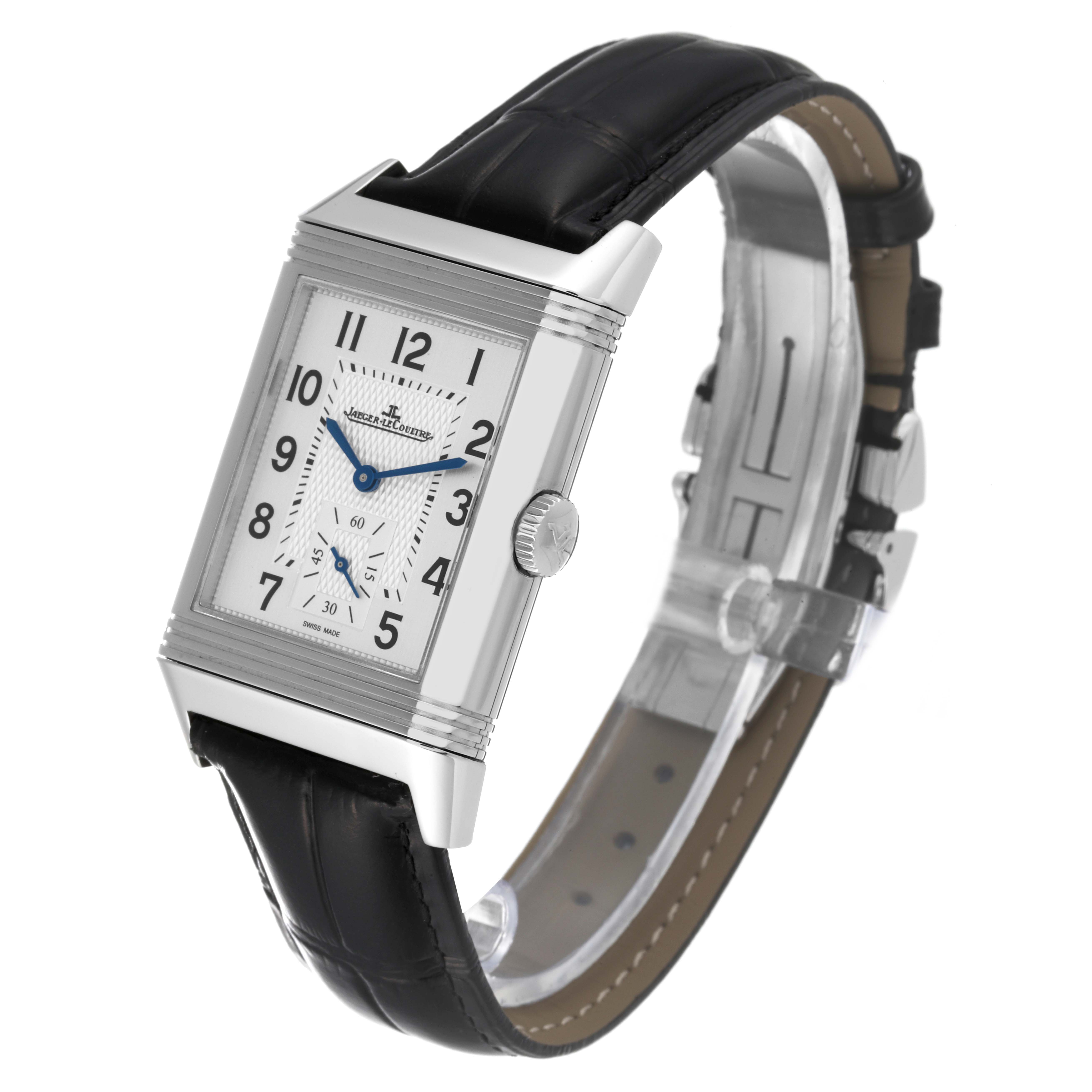 The image shows a Jaeger-LeCoultre Reverso watch at an angle displaying the dial, crown, and black leather strap.