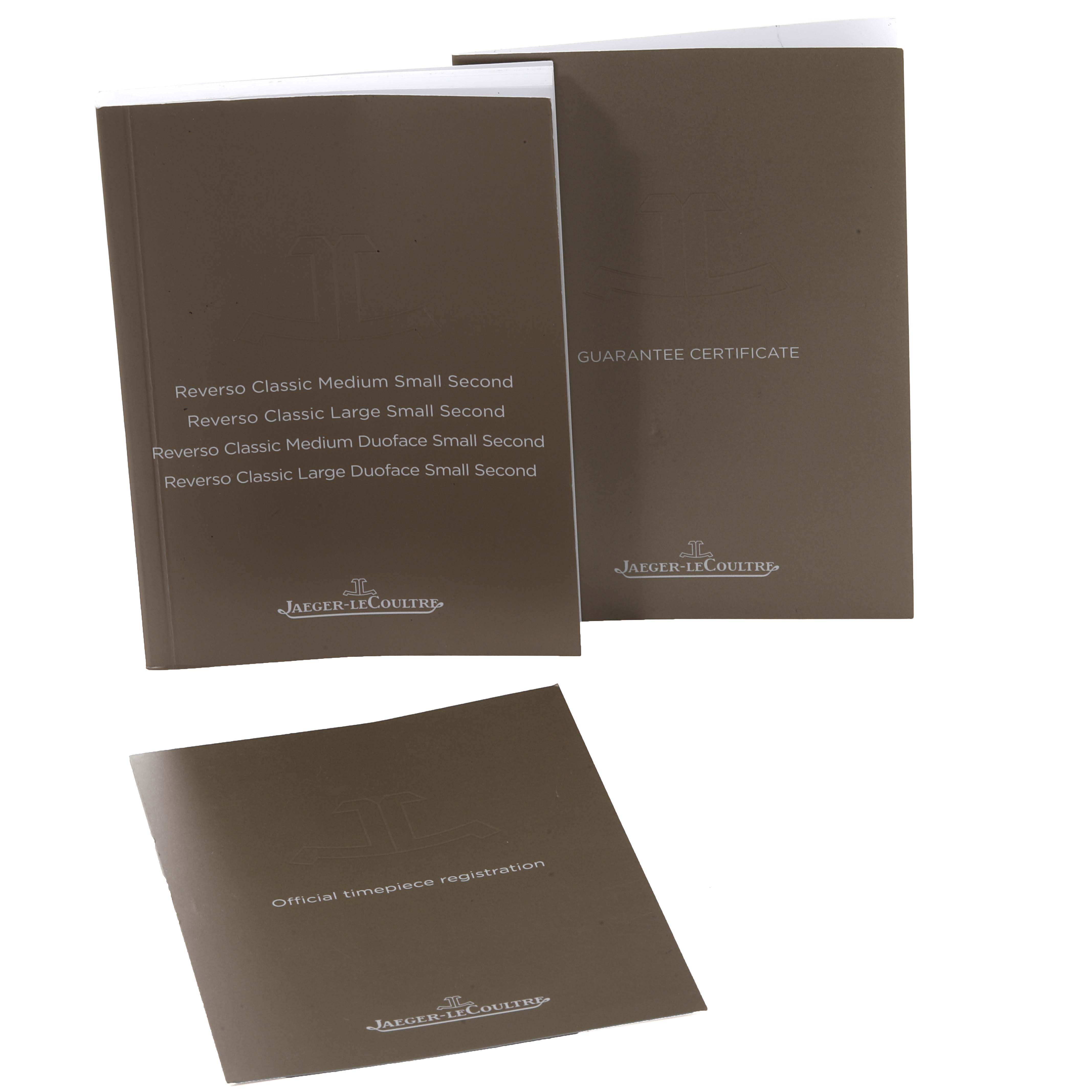 The image shows Jaeger-LeCoultre Reverso model booklets, including a guarantee certificate and official timepiece registration.