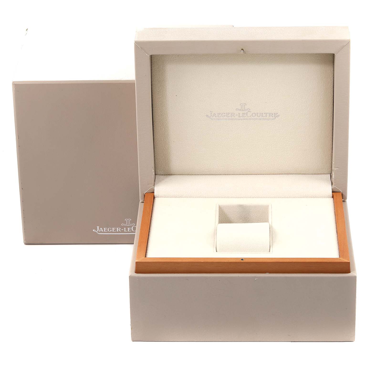 This image shows an open Jaeger-LeCoultre Reverso watch box, revealing the interior cushion and slots for the watch.