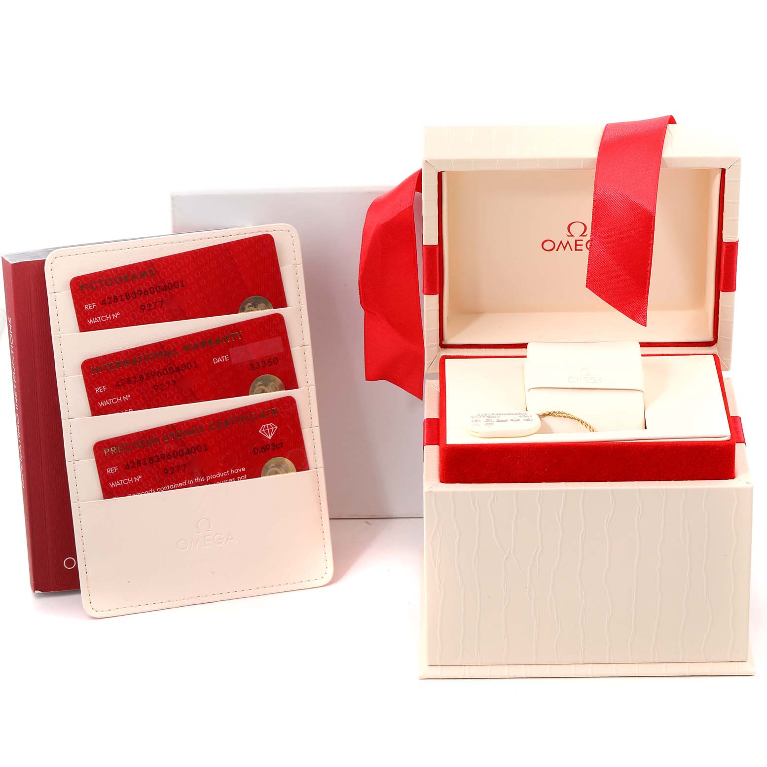 This image shows the packaging, warranty cards, and accessories for the Omega 428.18.39.60.04.001 Women's Stainless Steel White Dial 428.18.39.60.04.001 Women's Stainless Steel White Dial De Ville Tresor Steel Diamond Ladies Watch model 428.18.39.60.04.001.