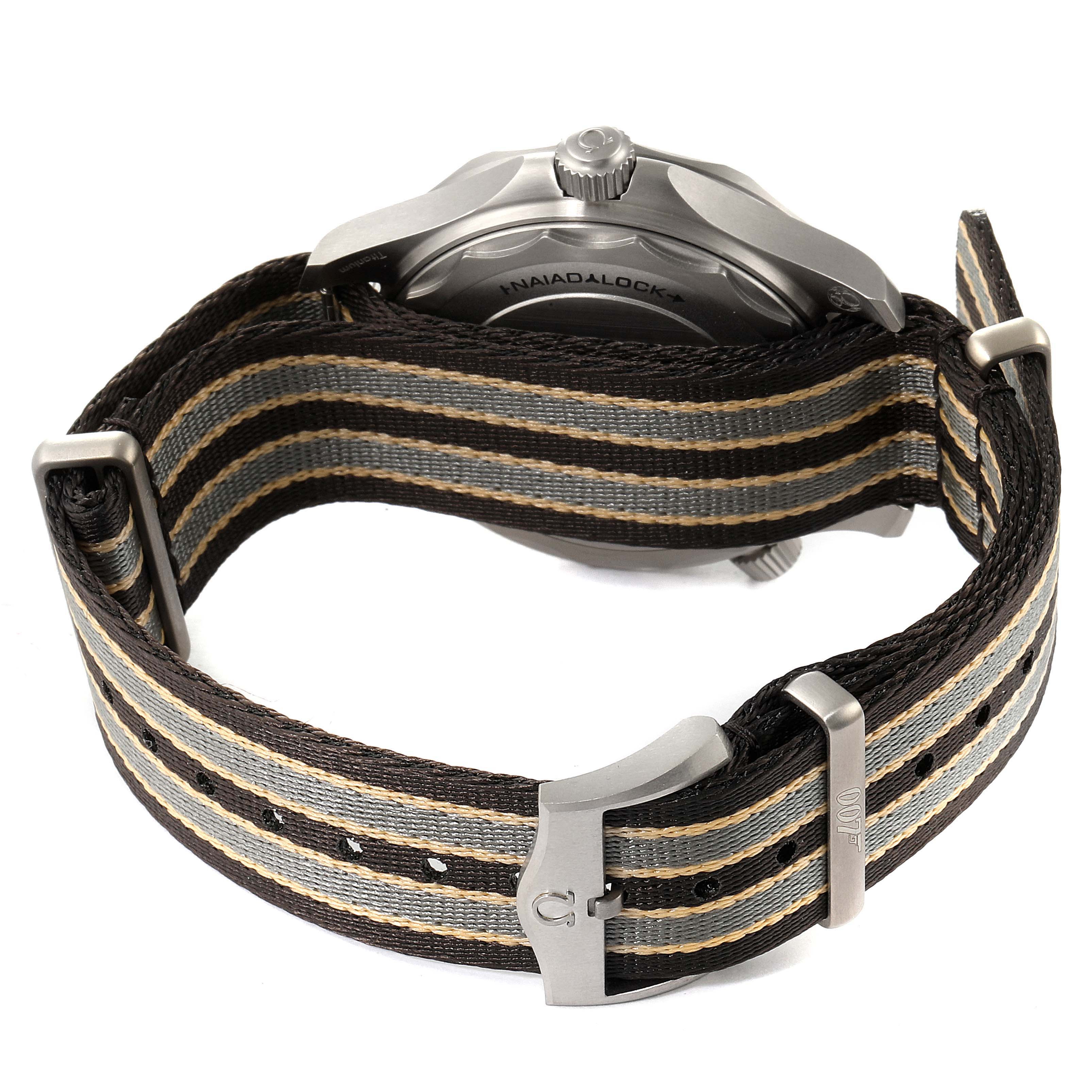 The image shows the back of an Omega Seamaster 210.92.42.20.01.001 Men's Titanium Brown Dial 210.92.42.20.01.001 Men's Titanium Brown Dial watch, highlighting its NATO strap and buckle.