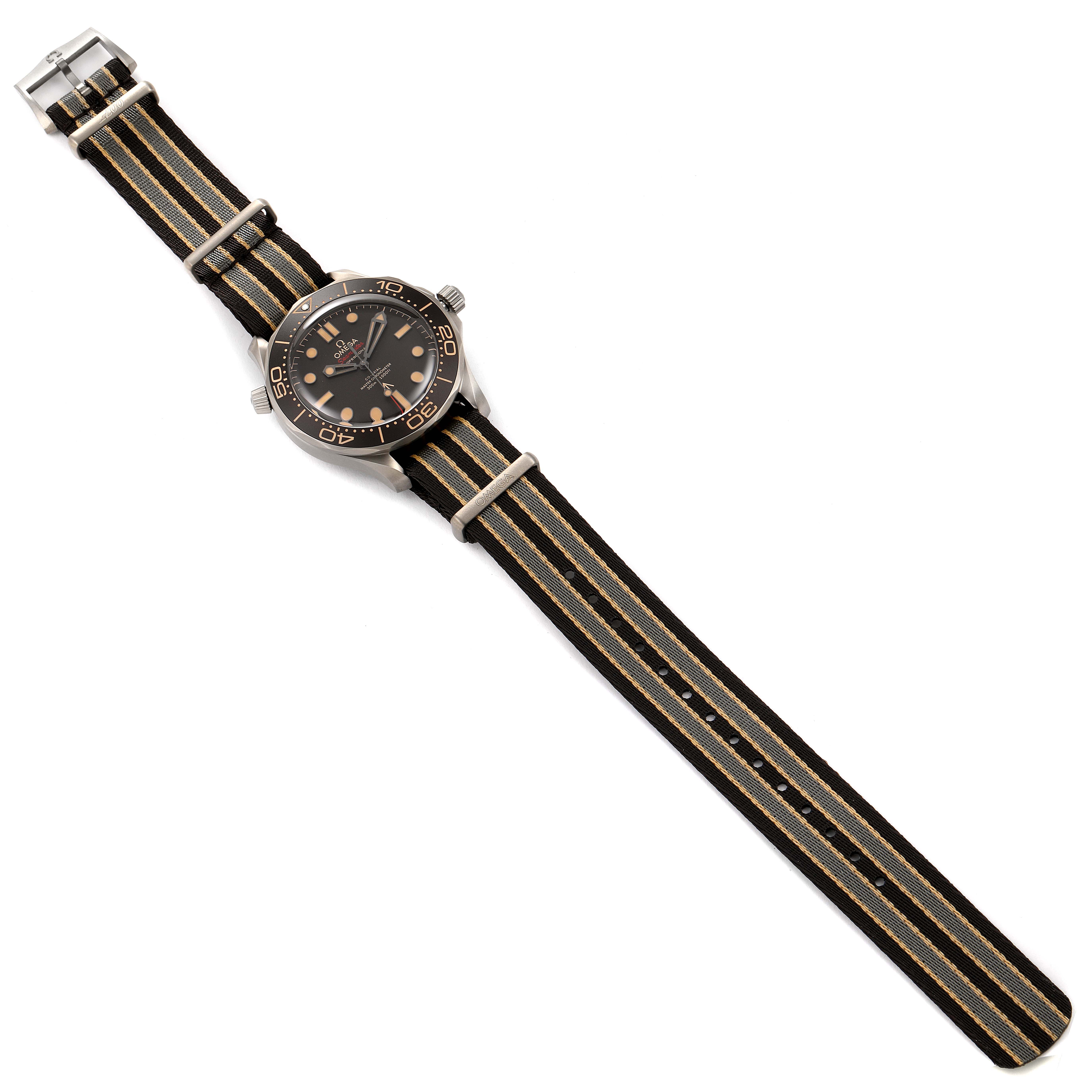 The Omega Seamaster 210.92.42.20.01.001 Men's Titanium Brown Dial 210.92.42.20.01.001 Men's Titanium Brown Dial watch is shown from a top-down angle, displaying its face, bezel, crown, and striped NATO strap.