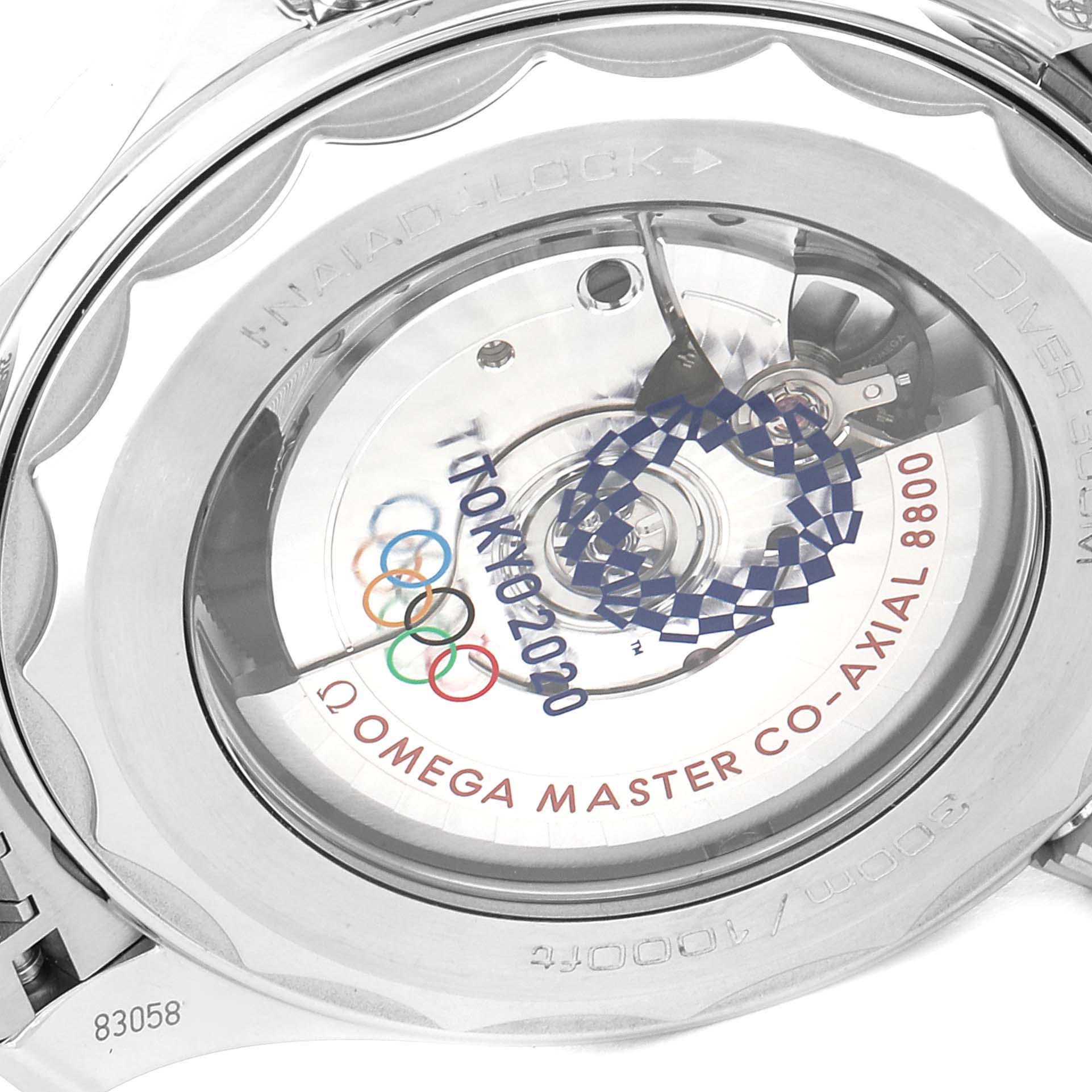 The image shows the case back of the Omega Seamaster 522.30.42.20.04.001 Men's Stainless Steel White Dial 522.30.42.20.04.001 Men's Stainless Steel White Dial watch, displaying the movement and special Tokyo 2020 engraving.