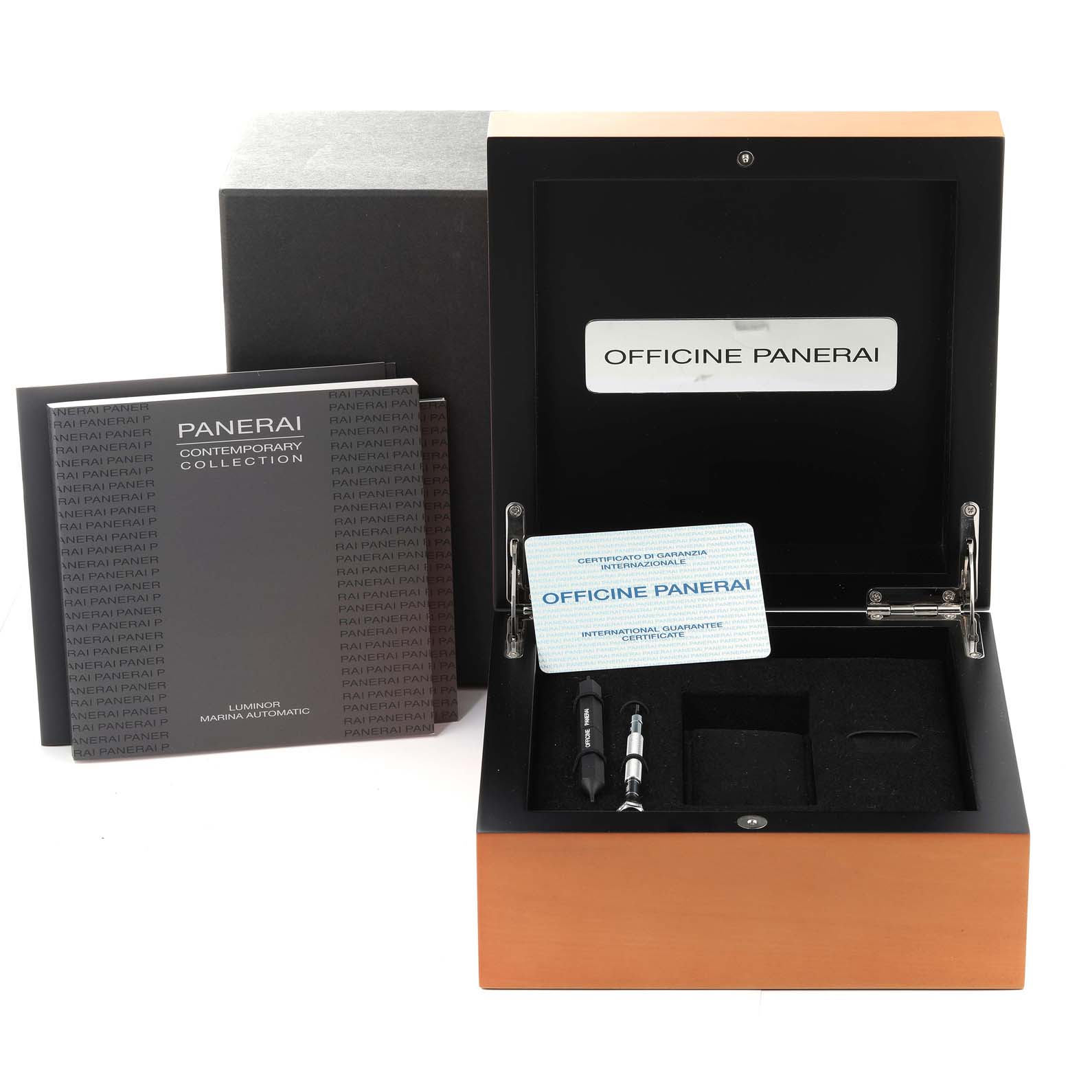 The image shows the packaging, tools, and warranty card for a Panerai Luminor PAM00104 Men
s Stainless Steel Black Dial PAM00104 Men
s Stainless Steel Black Dial watch, along with brand booklets from an overhead angle.