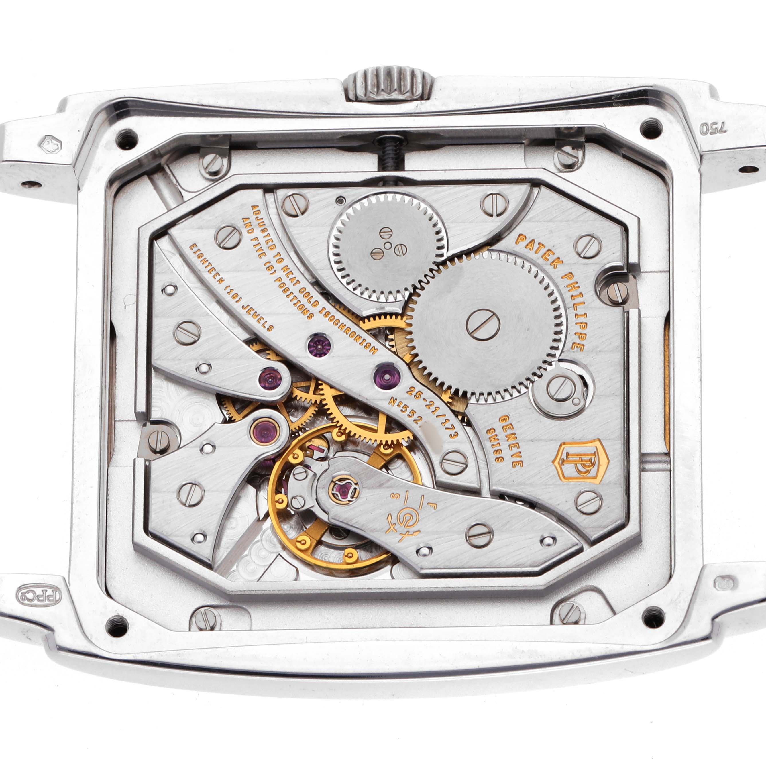 The image shows the movement of a Patek Philippe Gondolo 5124G Men's White Gold Brown Dial watch from a top-down angle, highlighting its gears and inner mechanisms.