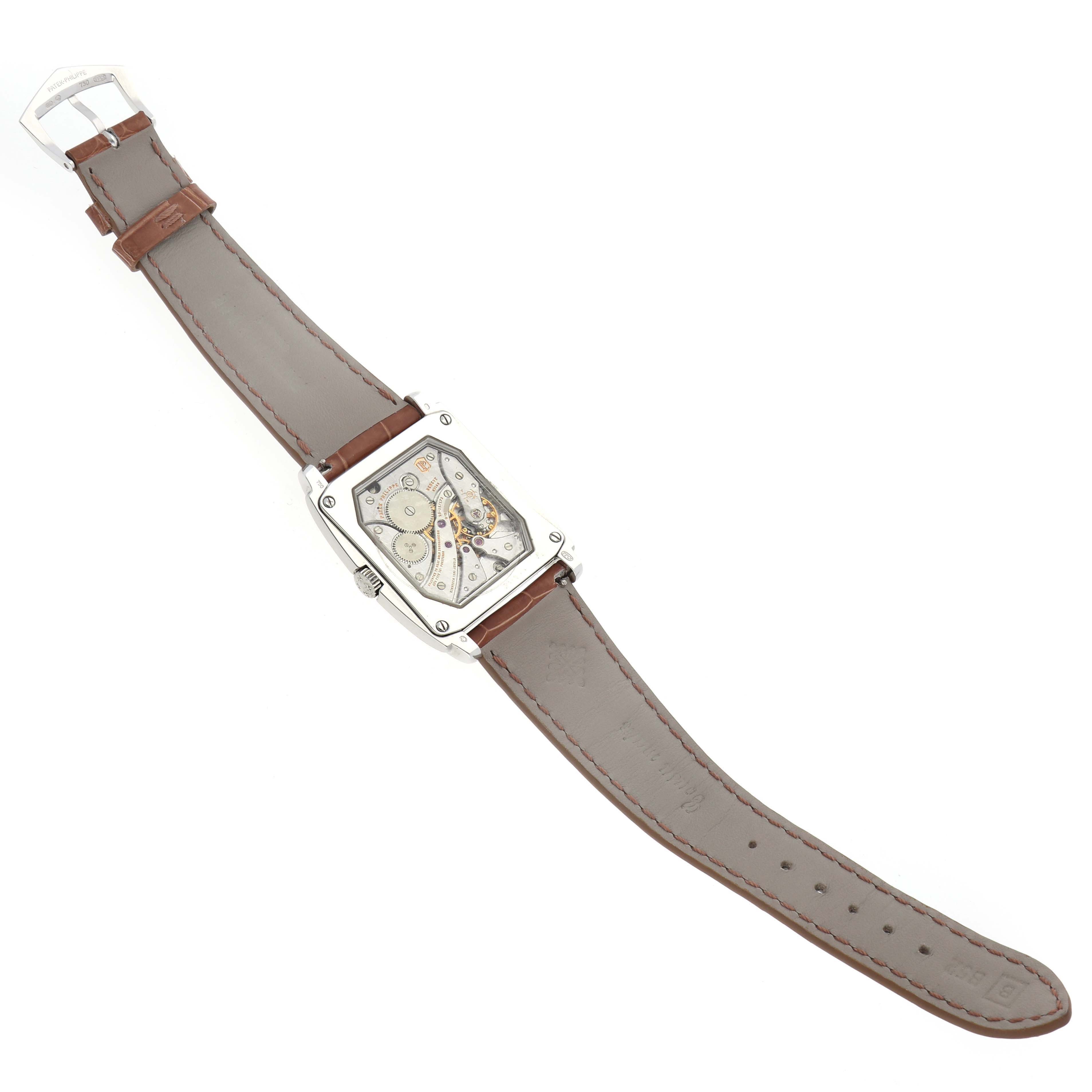 The Patek Philippe Gondolo 5124G Men's White Gold Brown Dial watch is shown at an angle highlighting the transparent back and leather strap.