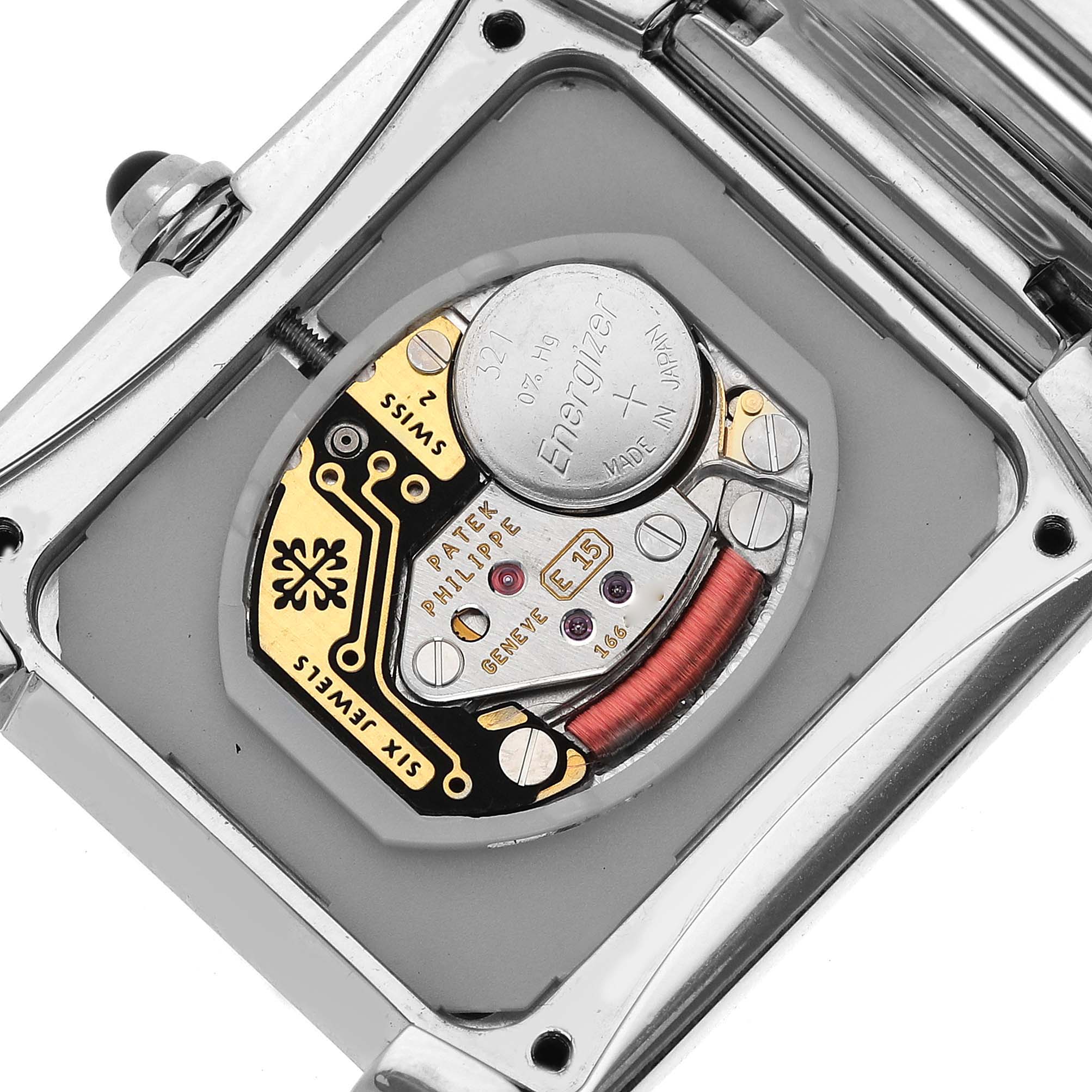 The image shows the open case back of a Patek Philippe Twenty-4 4910A Women's Stainless Steel Silver Dial, revealing its battery and inner mechanisms.