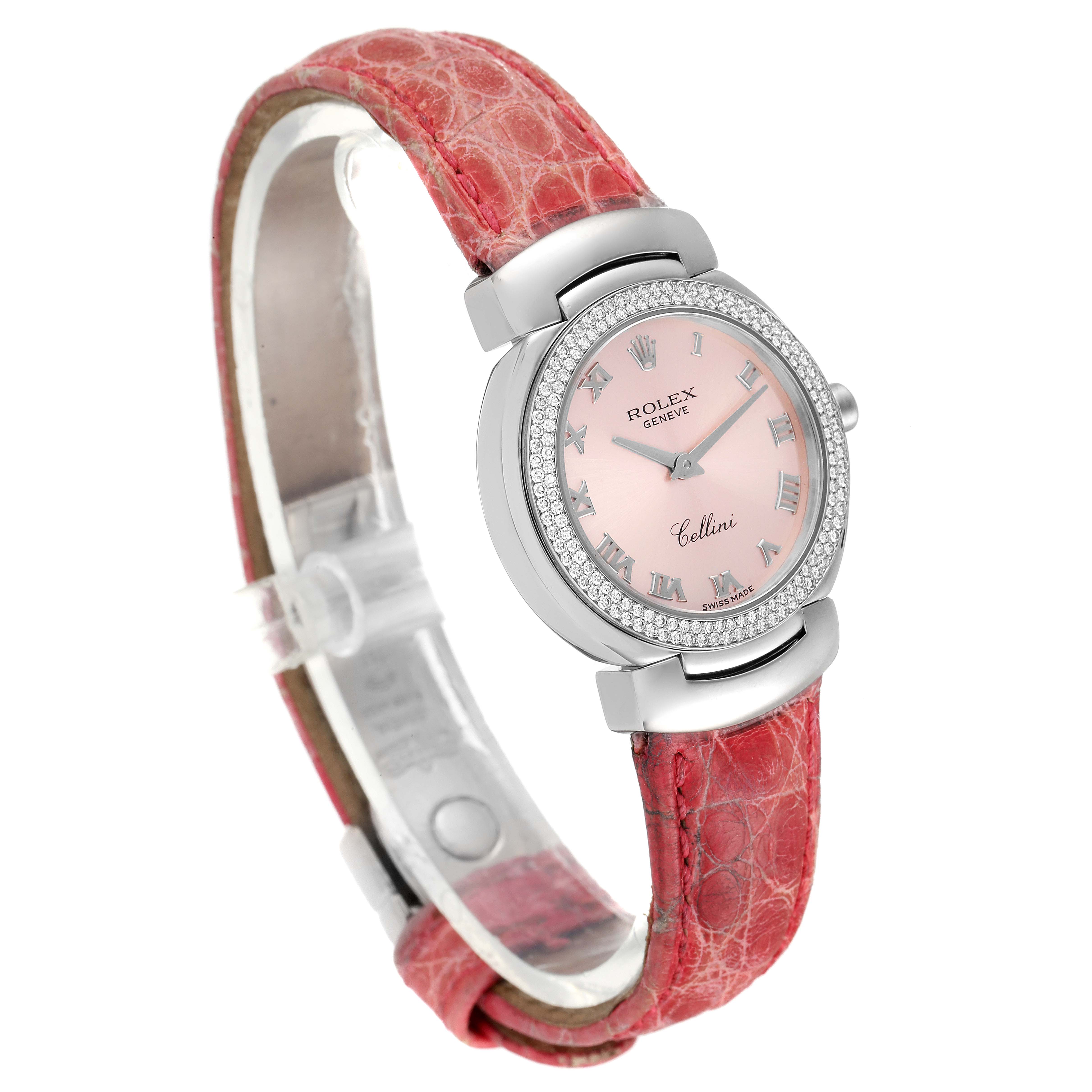 The Rolex Cellini 6671 Women's White Gold Pink Dial 6671 Women's White Gold Pink Dial watch is shown from a front angle, displaying its pink dial, diamond bezel, and red leather strap.