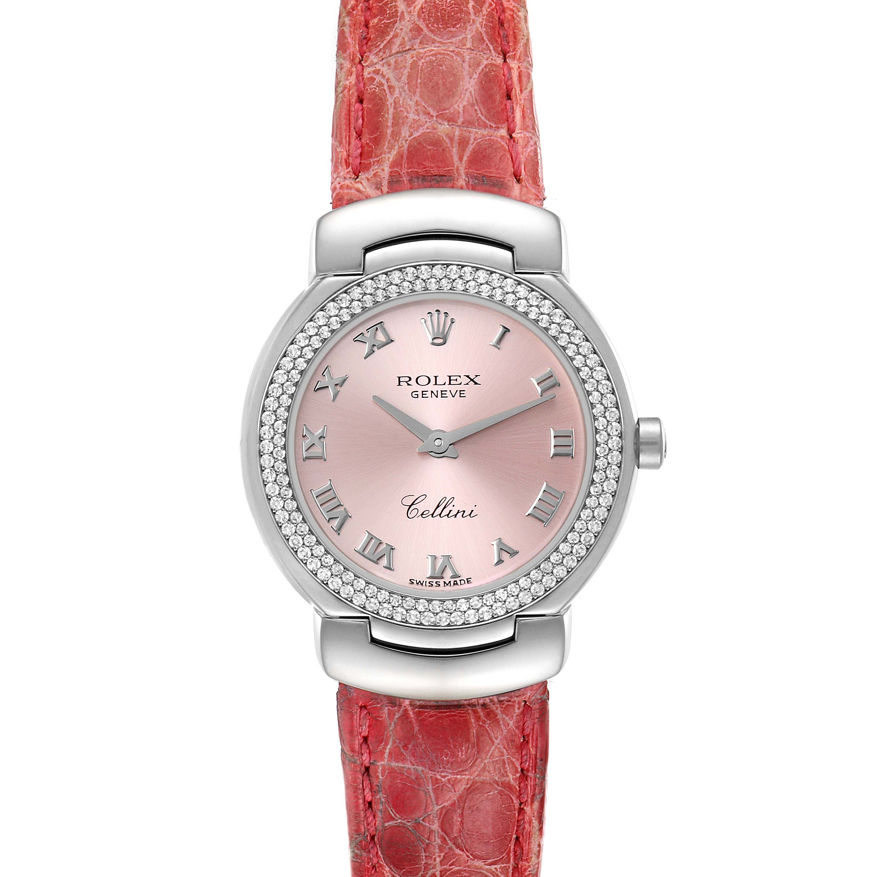 The Rolex Cellini 6671 Women's White Gold Pink Dial 6671 Women's White Gold Pink Dial watch is shown from a top-down angle, showcasing its pink dial, Roman numeral markers, and red leather strap.