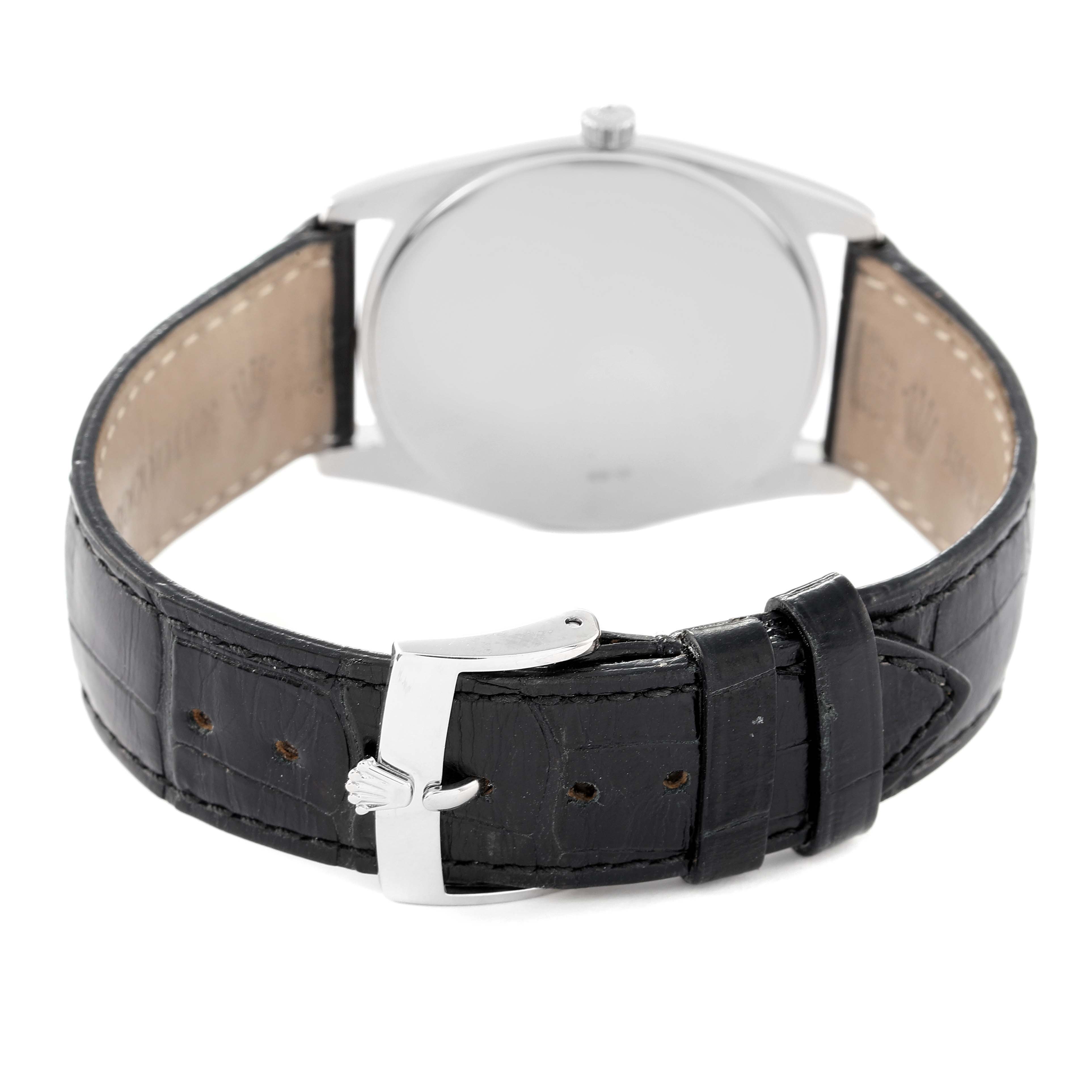 The image shows the back view of a Rolex Cellini 4233 Men
s White Gold Black Dial 4233 Men
s White Gold Black Dial watch, highlighting the black leather strap and clasp.