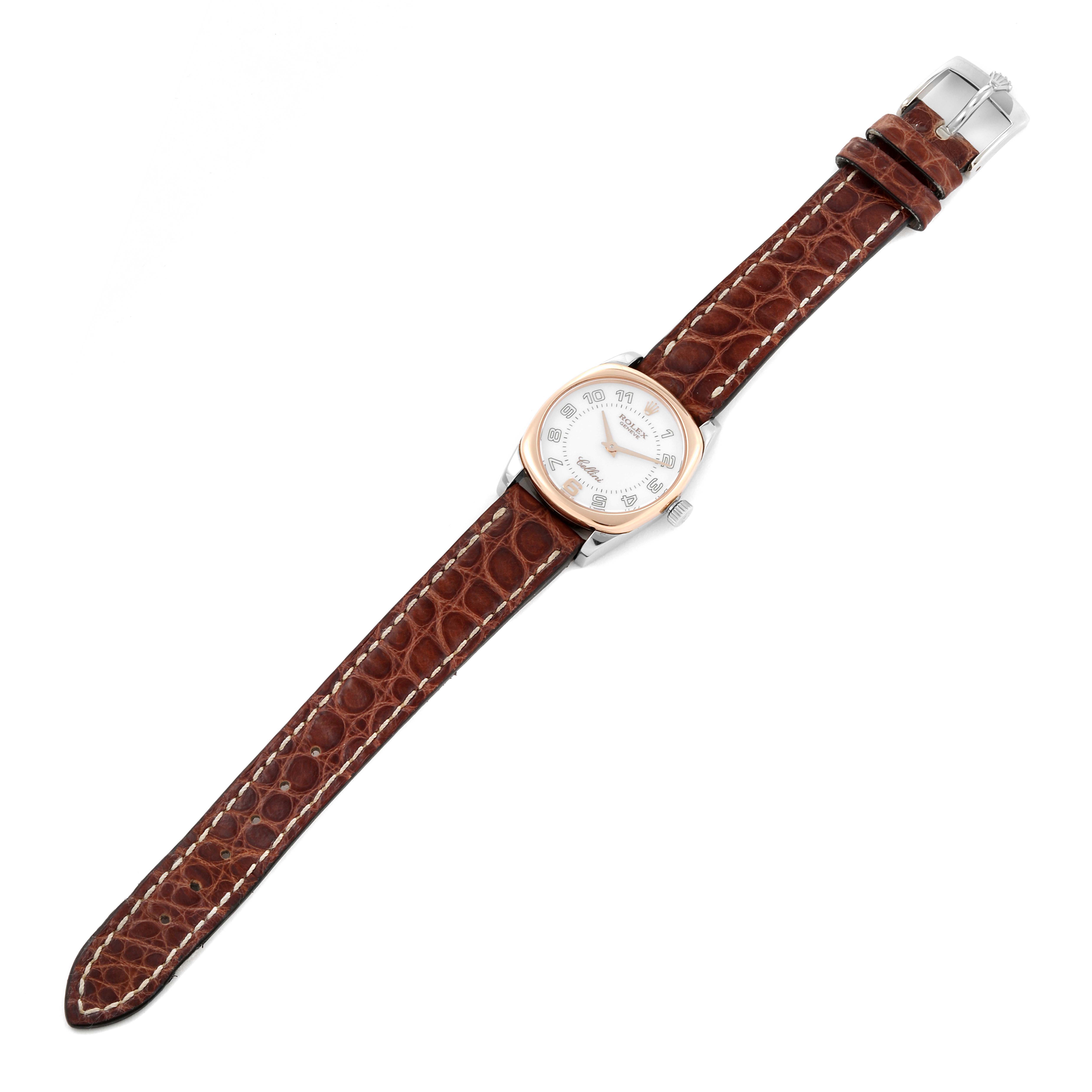 The Rolex Cellini 6229 Women
s Steel and Gold (two tone) White Dial 6229 Women
s Steel and Gold (two tone) White Dial watch is shown from a top-down angle, showcasing its dial, case, and brown leather strap.