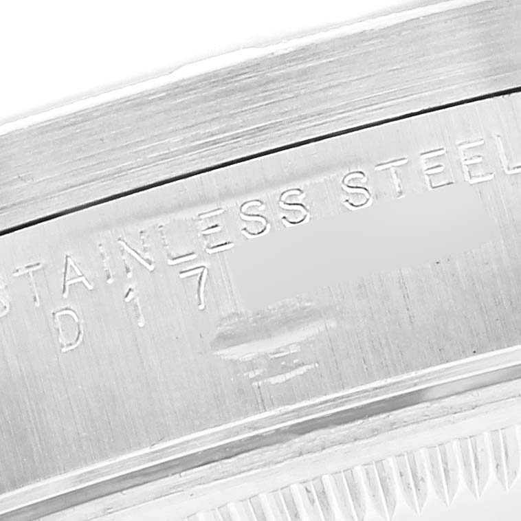 This image shows a close-up of the case side of a Rolex Date 15210 Men's Stainless Steel Black Dial 15210 Men's Stainless Steel Black Dial model, specifically focusing on the engraved serial and material details.