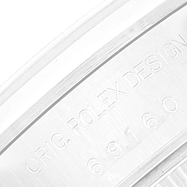 The image shows part of the caseback of a Rolex Date 69160 Women
s Stainless Steel Blue Dial 69160 Women
s Stainless Steel Blue Dial model, displaying the engraved serial and design numbers.