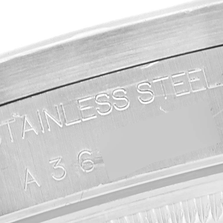 This image shows a close-up of the inner engraving on the stainless steel casing of a Rolex Date 15210 Men's Stainless Steel White Dial 15210 Men's Stainless Steel White Dial model watch.