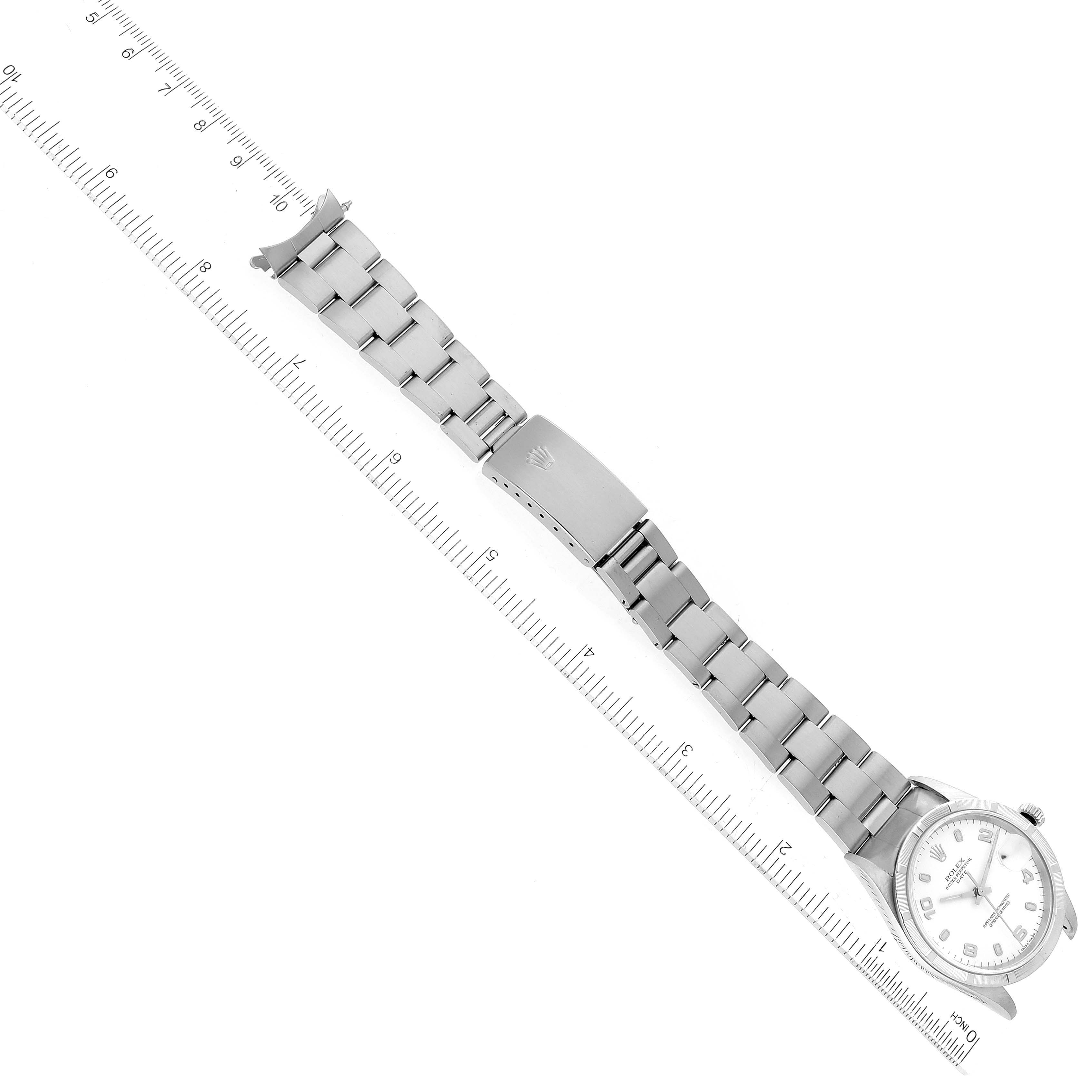 The image shows a top view of a Rolex Date 15210 Men's Stainless Steel White Dial 15210 Men's Stainless Steel White Dial model watch with its full metal bracelet and clasp, alongside a ruler for scale.