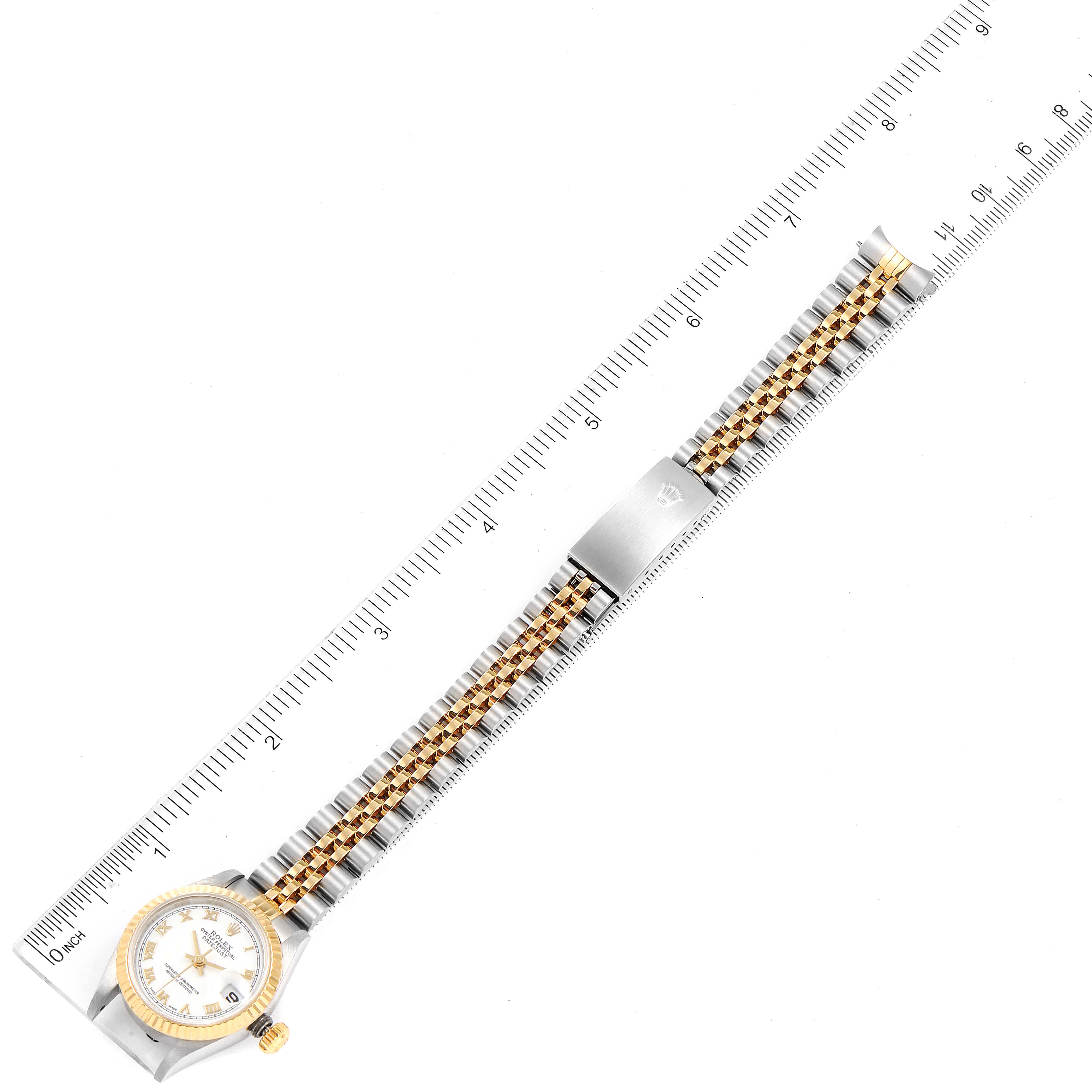 The image shows the full length of a Rolex Datejust 79173 Women's Steel and Gold (two tone) White Dial 79173 Women's Steel and Gold (two tone) White Dial watch, including the face, bracelet, and clasp, positioned alongside a ruler.