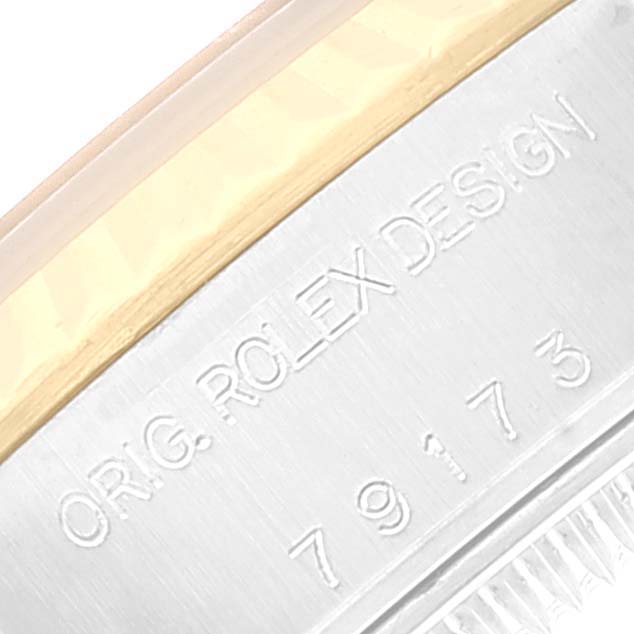 This close-up angle shows the bezel and engraved casing of the Rolex Datejust 79173 Women's Steel and Gold (two tone) White Dial 79173 Women's Steel and Gold (two tone) White Dial.