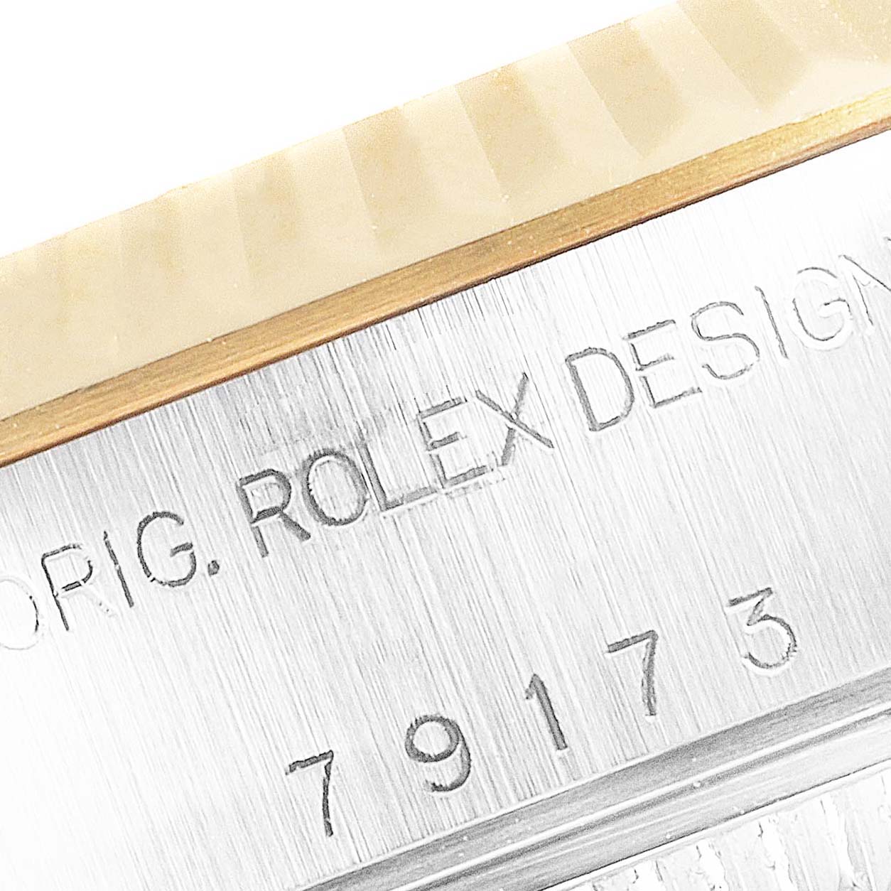 This image shows the side view of a Rolex Datejust 69173 Women's Steel and Gold (two tone) Champagne Dial 69173 Women's Steel and Gold (two tone) Champagne Dial watch, highlighting the engraving and model number.